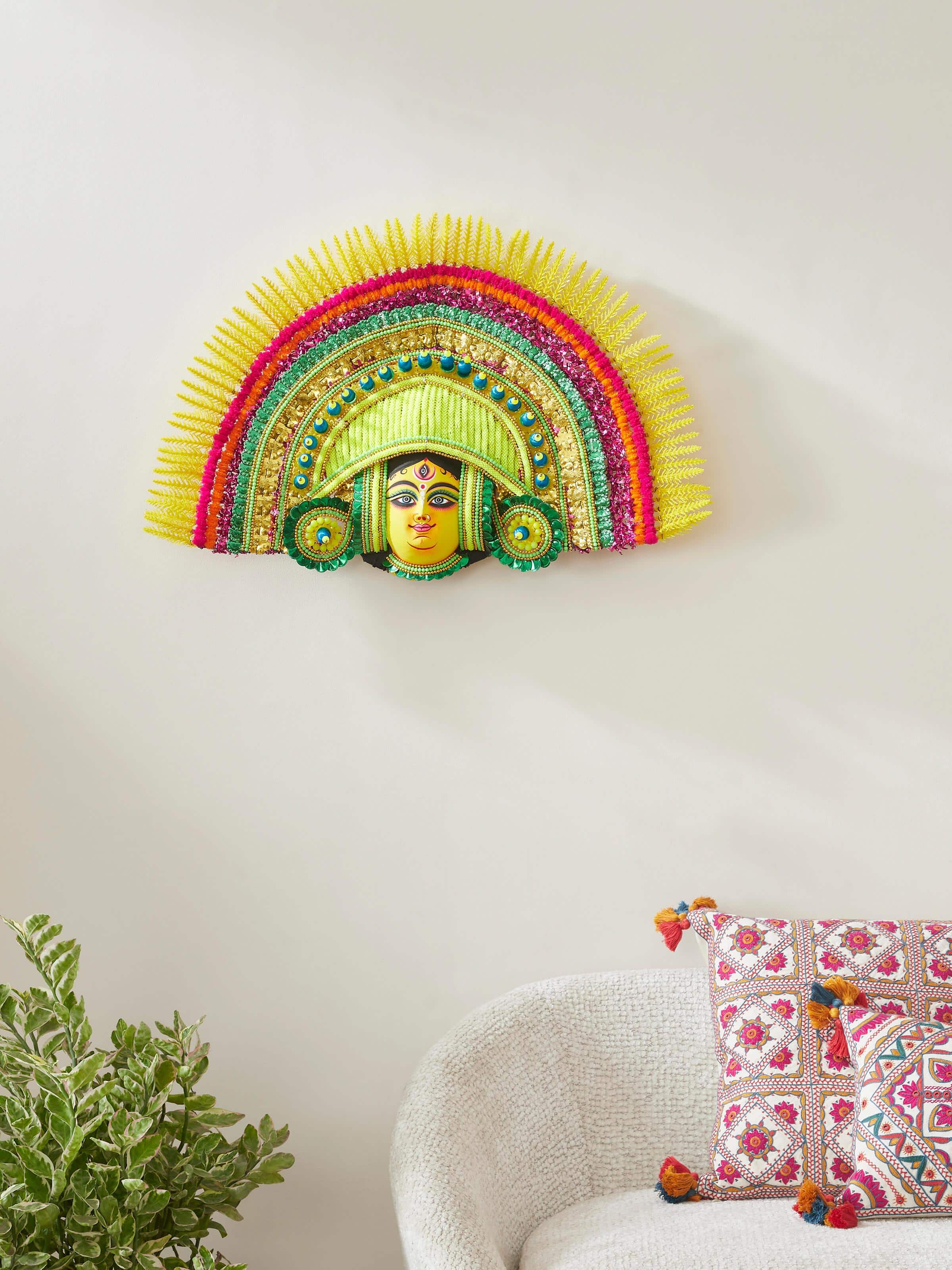 Front view of a clay and paper Chhau wall mask, highlighting its intricate features and vivid color patterns.