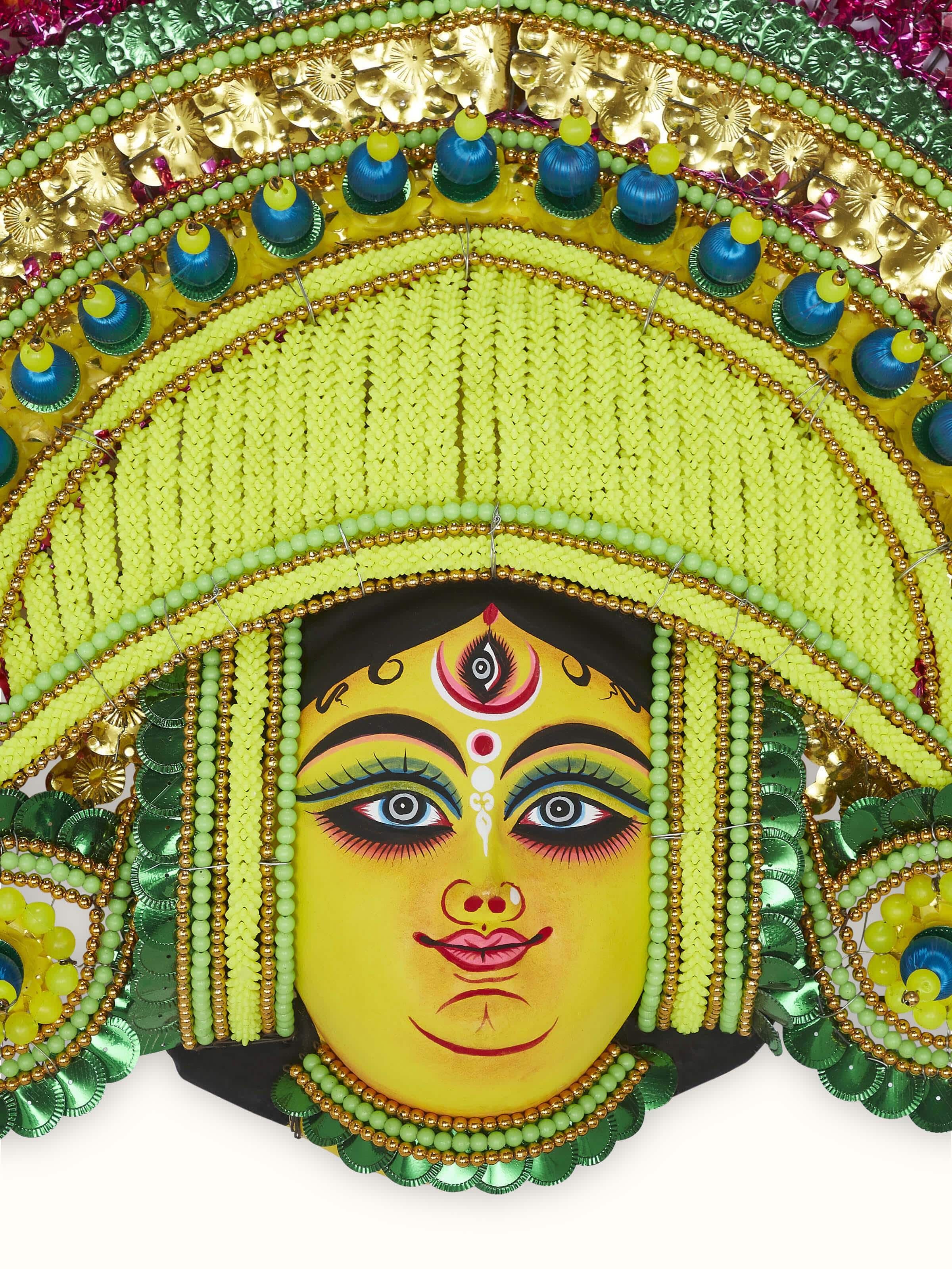 Side view of a clay and paper Chhau wall mask, emphasizing its detailed craftsmanship and unique design.