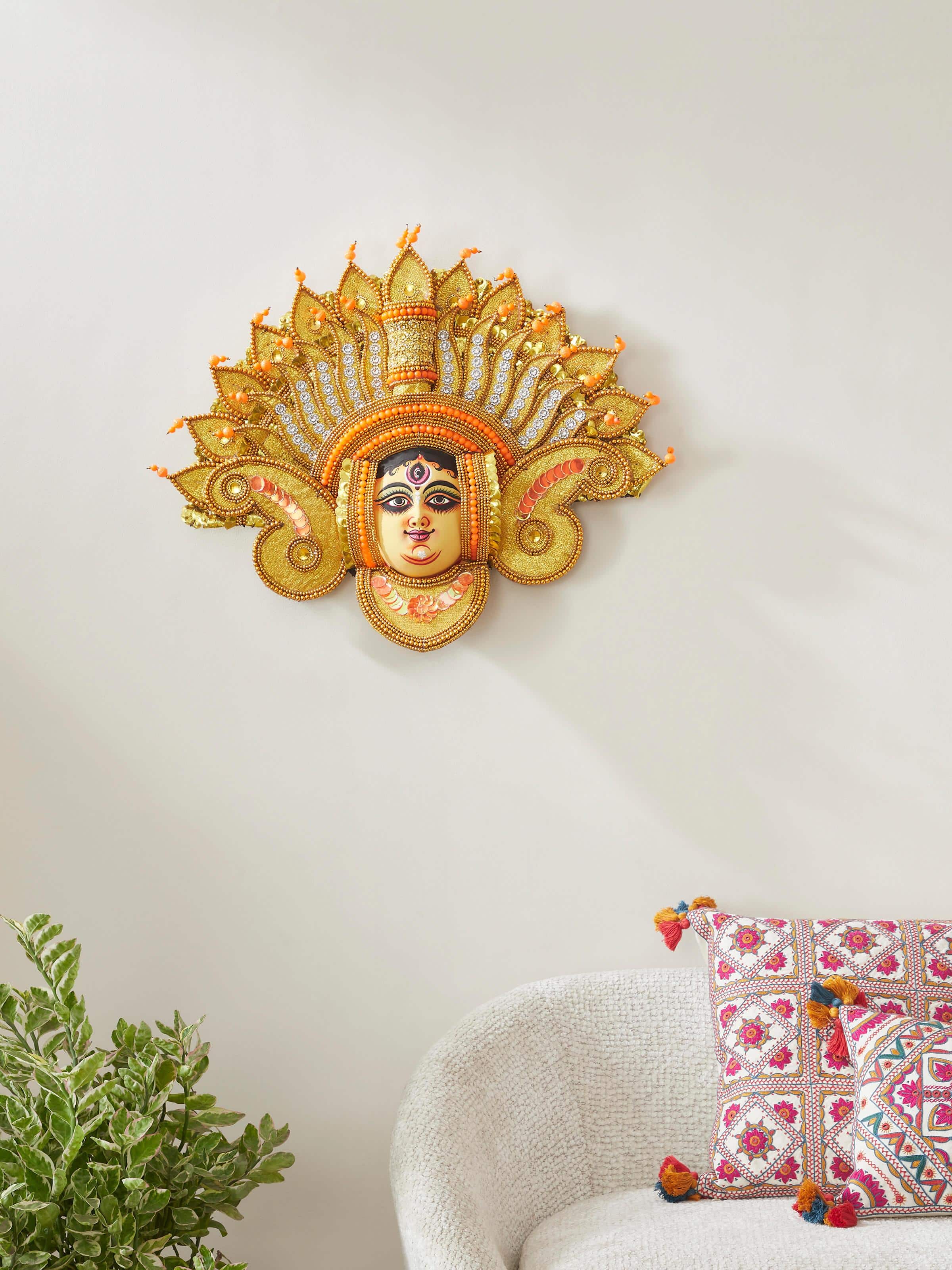 Close-up view of Chhau Devi wall mask made from clay and paper, focusing on its elaborate design.