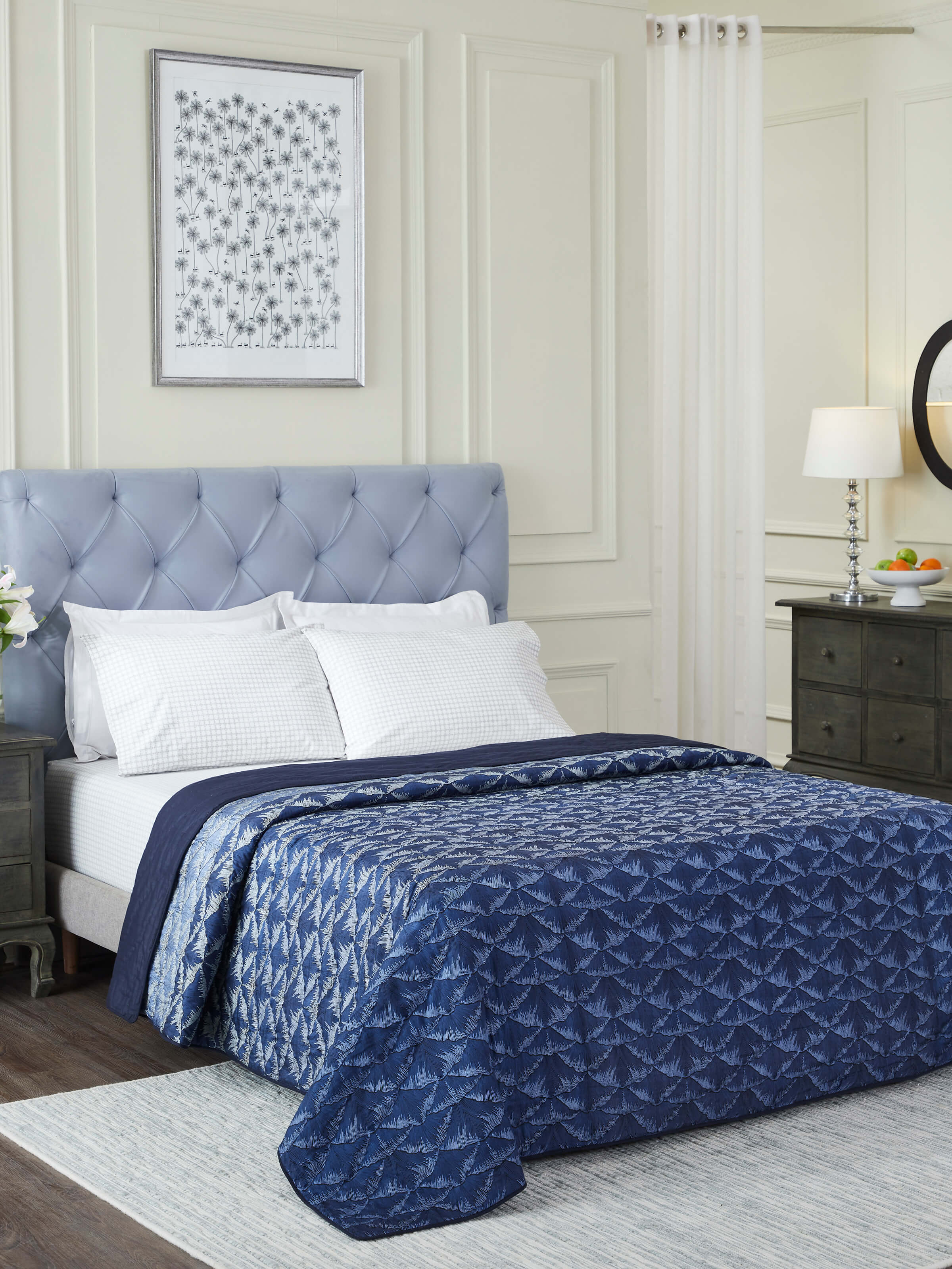 Close-up view of the Parvat indigo ombre silk quilt highlighting the block printed design