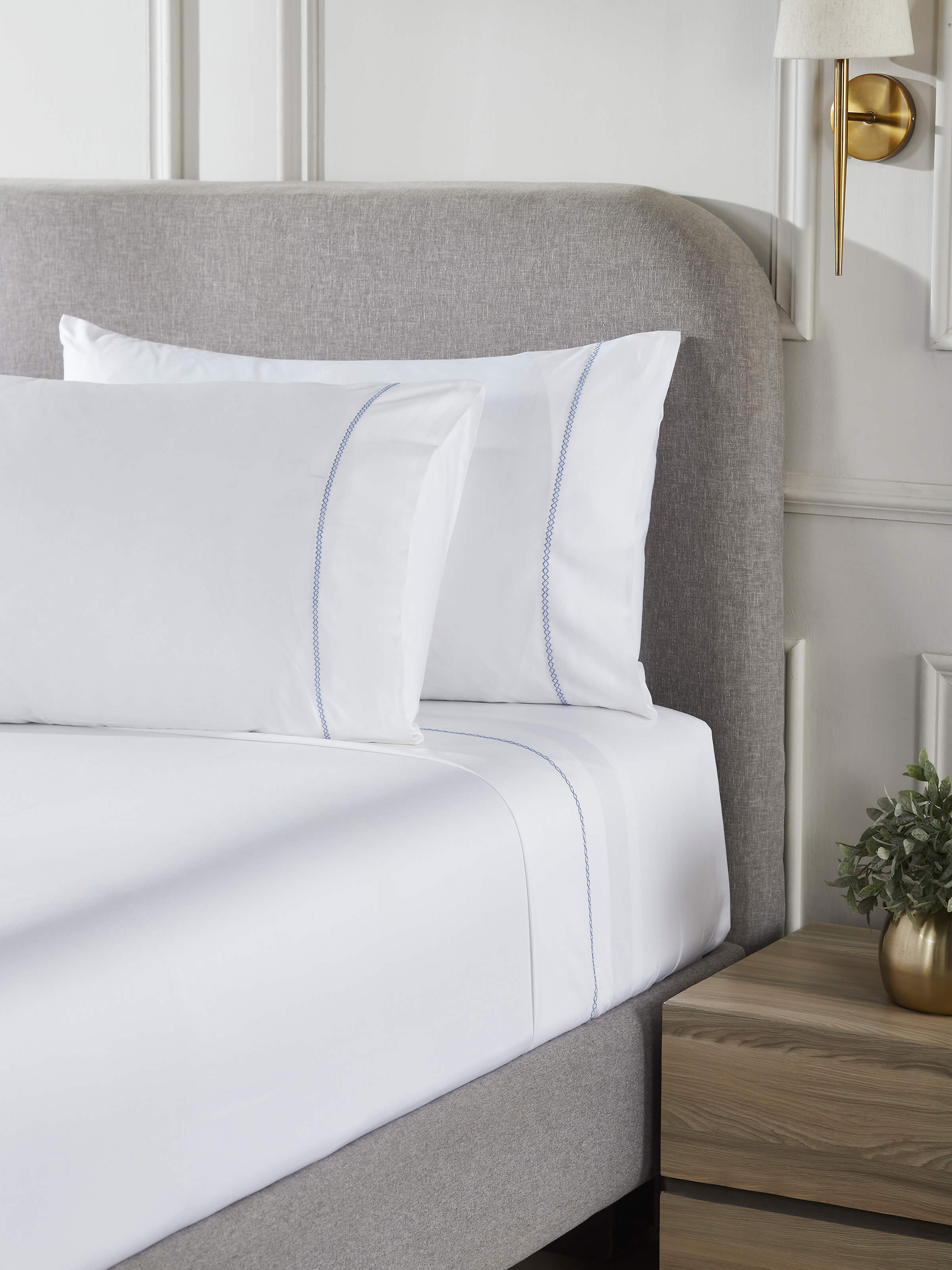 Close-up of the Parvat blue stripe cotton king bedsheet set with detailed hand embroidery