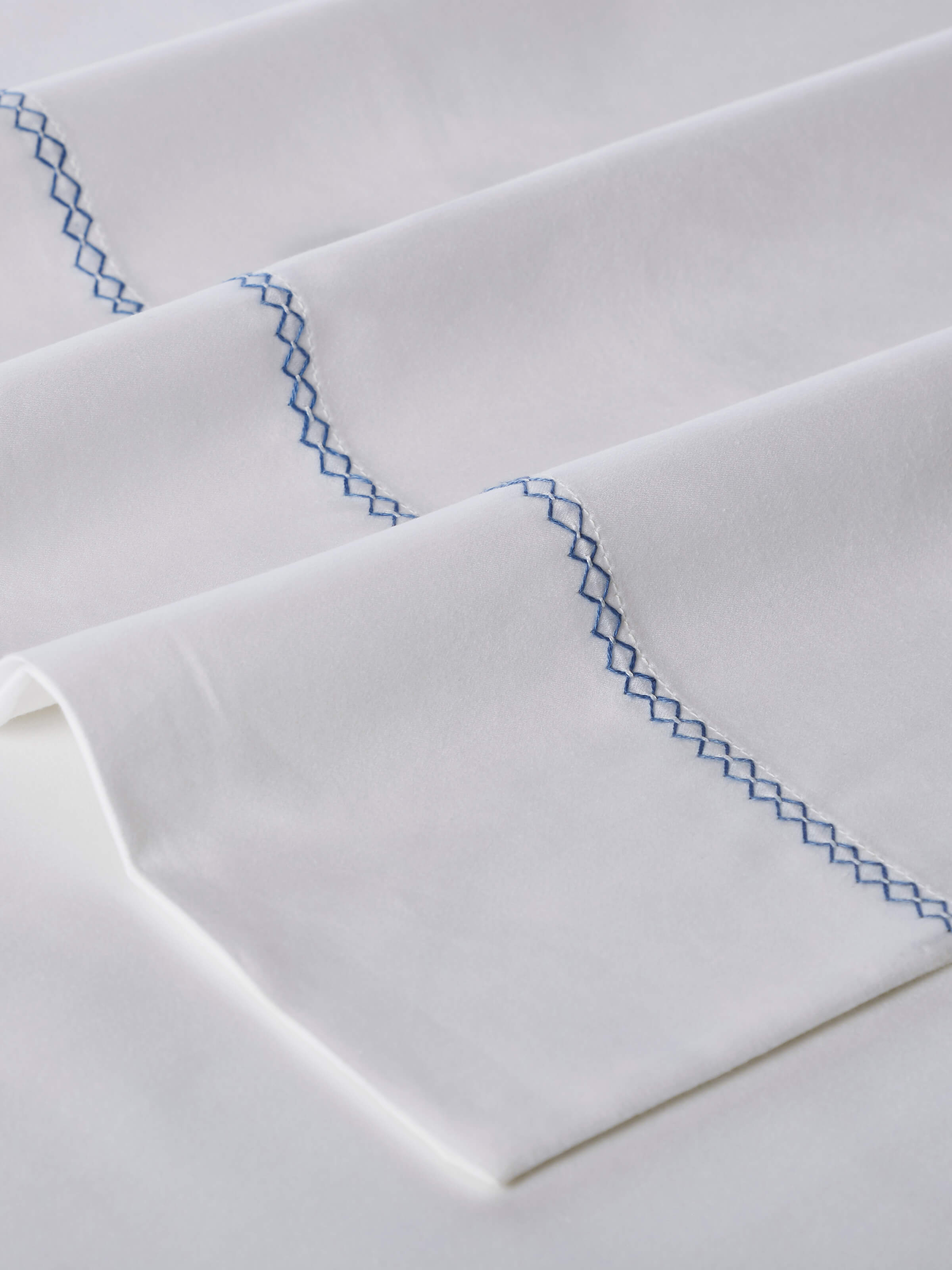 Parvat blue stripe cotton king bedsheet set, highlighting the elegant hand-embroidered patterns