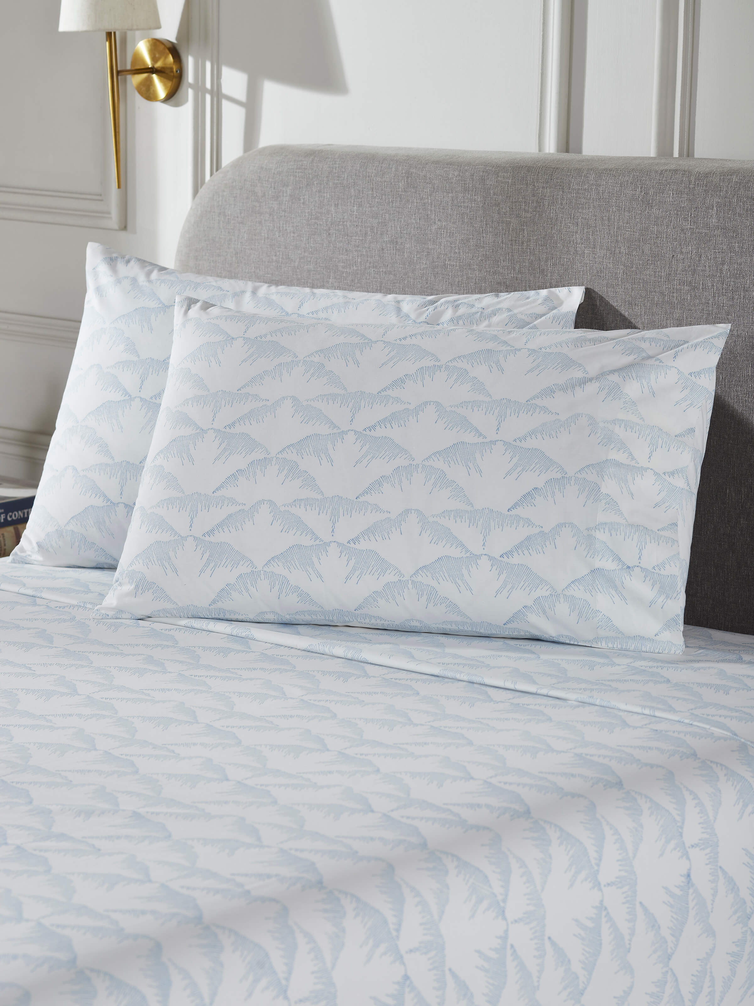 Side view of Parvat blue textured cotton Sanganeri block printed queen bedsheet set focusing on the fabric texture