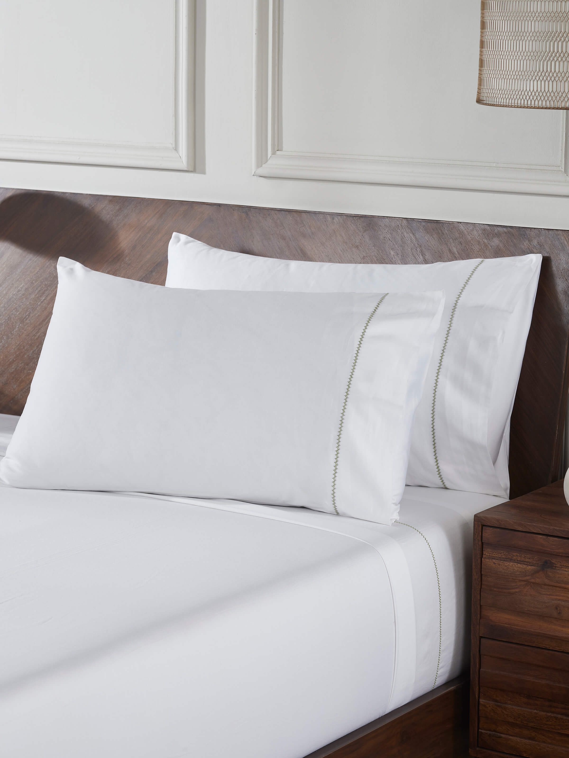 Close-up of Parvat beige stripe cotton hand embroidered bedsheet king set focusing on the detailed hand embroidery and stripe pattern.