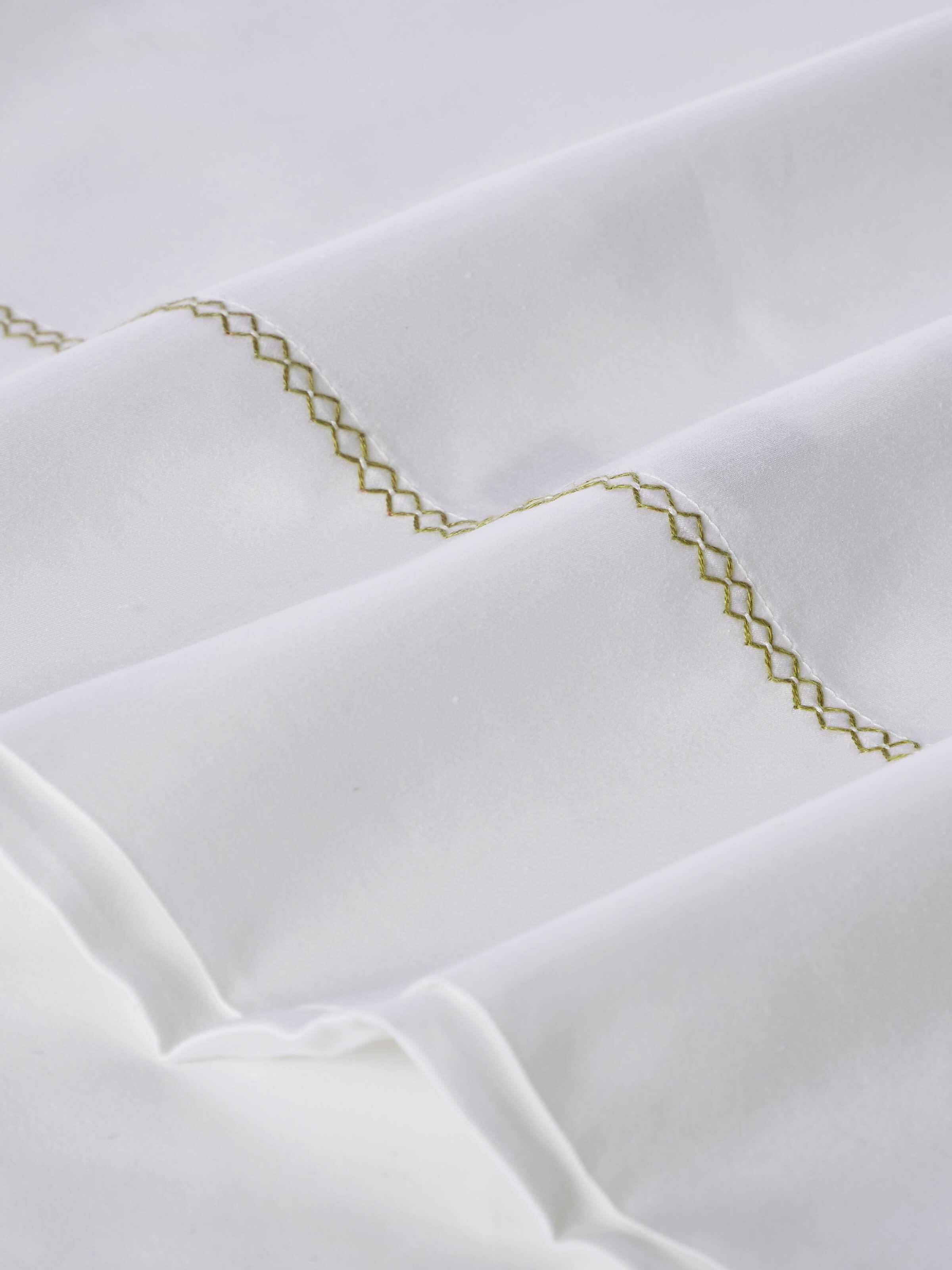 Parvat beige stripe cotton hand embroidered bedsheet king set folded to highlight the striped pattern and embroidery details.
