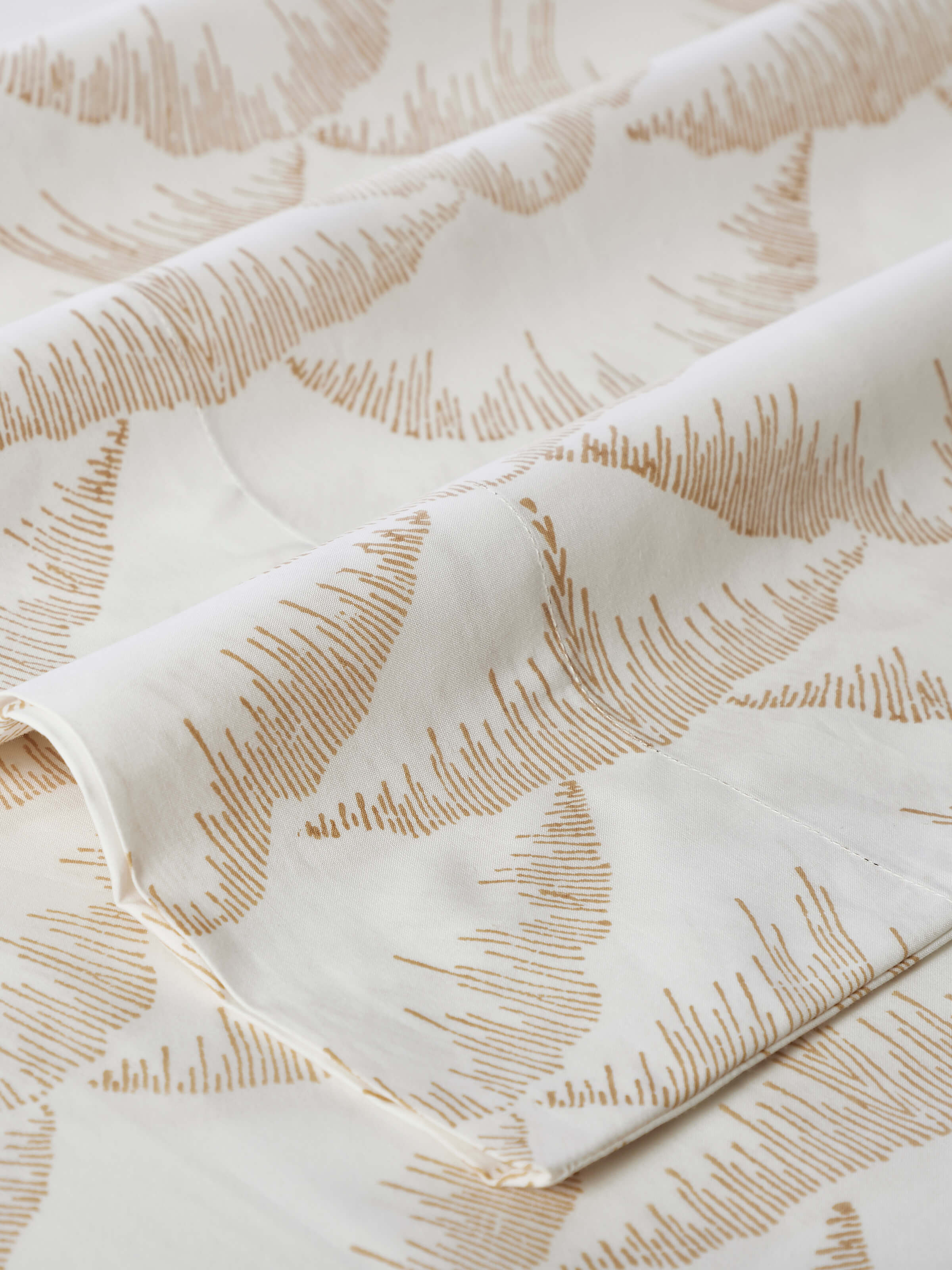 Parvat beige textured cotton Sanganeri block printed queen bedsheet set (3 pcs) arranged to show its use and design in a bedroom setting.