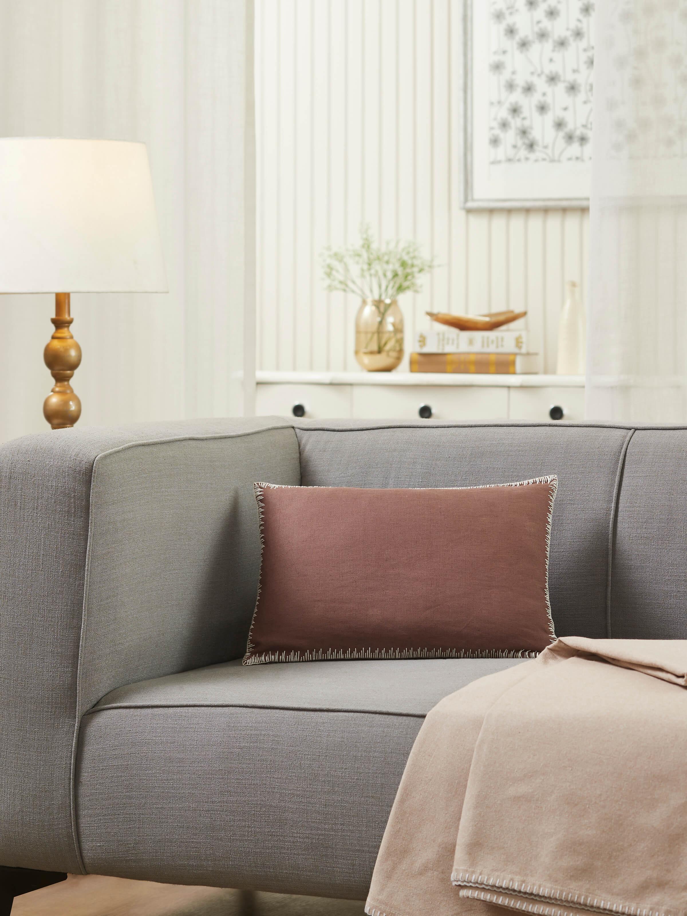 Close-up of Parvat brown edge stitch linen cotton cushion cover showcasing the detailed edge stitch embroidery