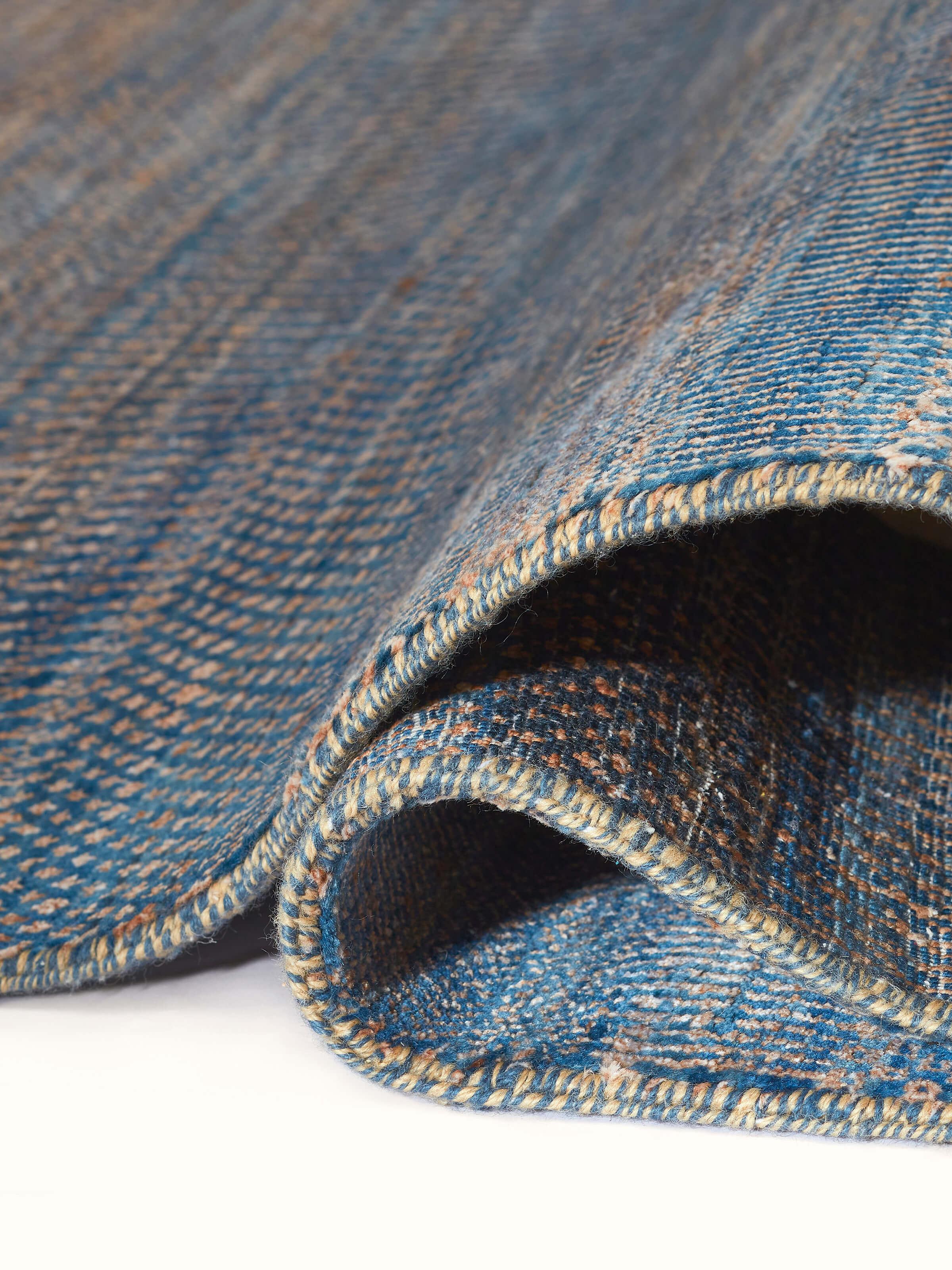 Side detail of grass pattern grey wool viscose hand-knotted Agra carpet