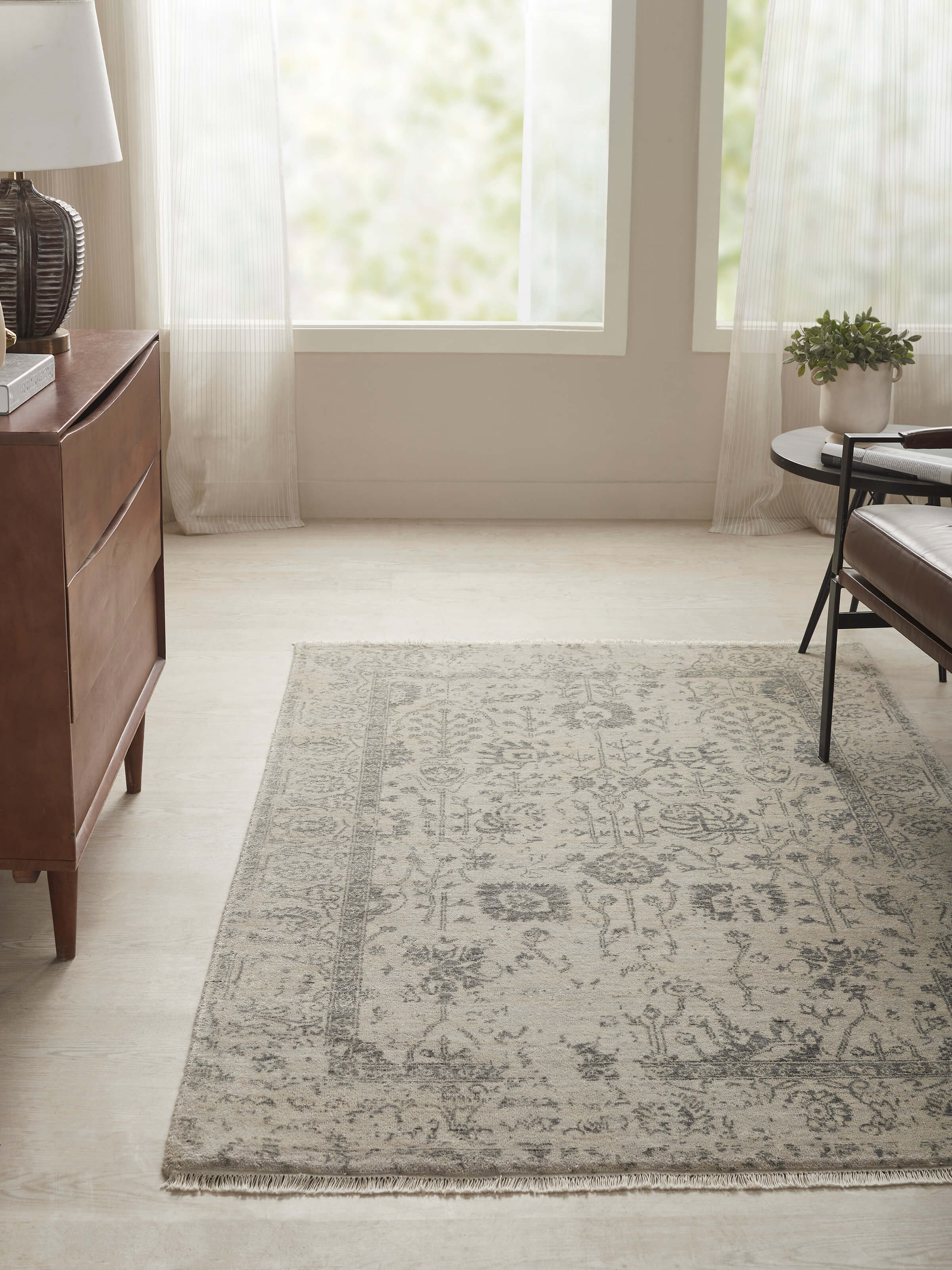 Close-up view of the distressed transitional charcoal Agra carpet, showcasing its detailed hand-knotted pattern and depth of color