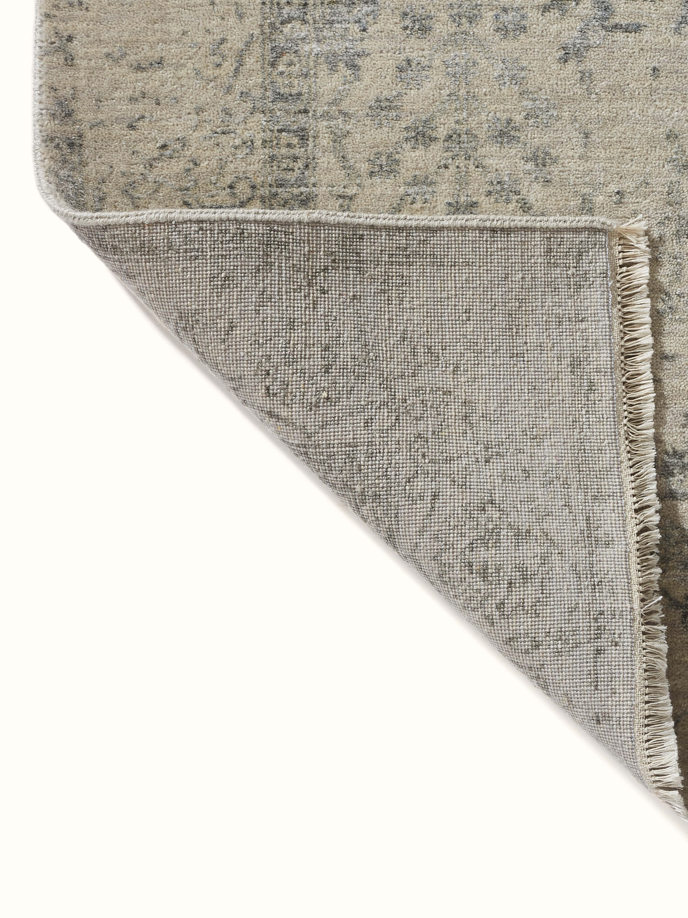 Top-down view of the distressed charcoal Agra wool and viscose carpet, emphasizing its transitional design and hand-knotted craftsmanship