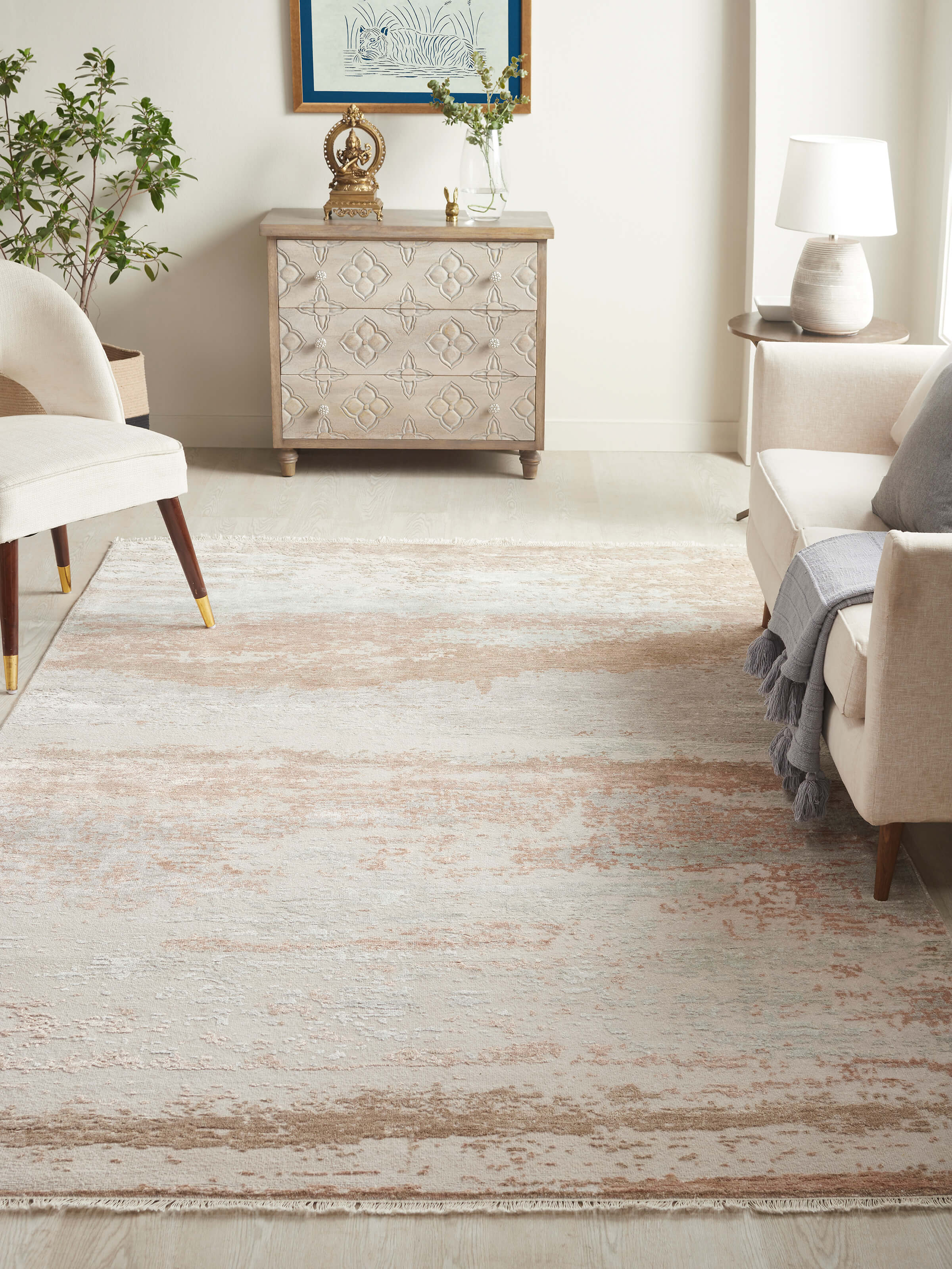 Abstract modern hand-knotted beige rug placed in a neutral-toned modern living space