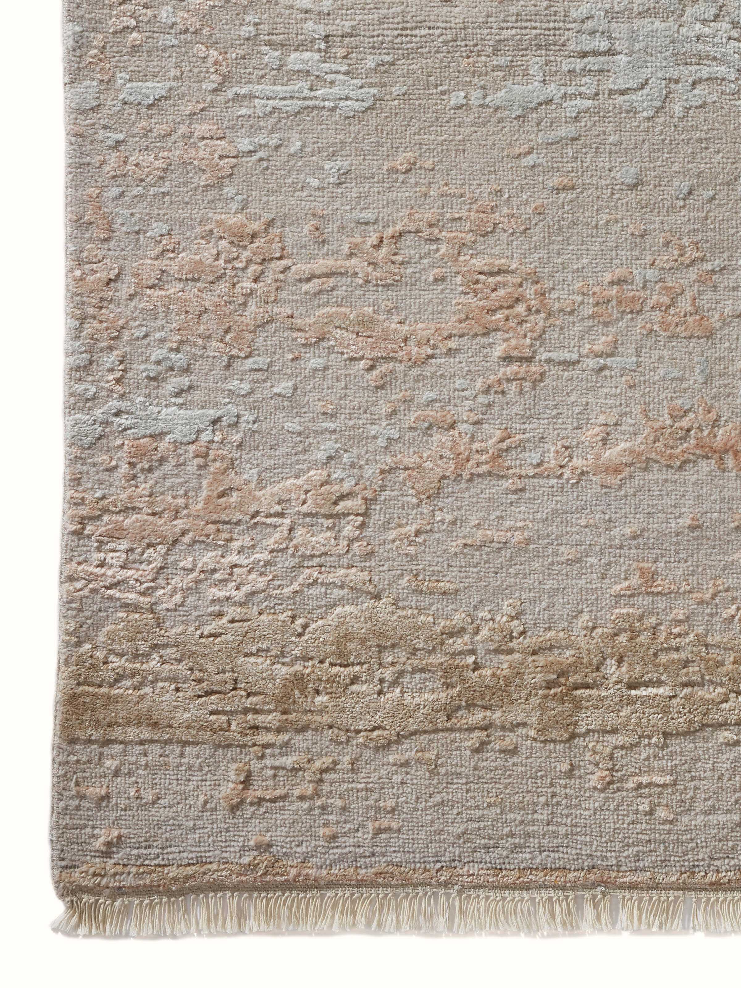 Close-up of abstract beige carpet showcasing hand-knotting detail and wool-viscose texture