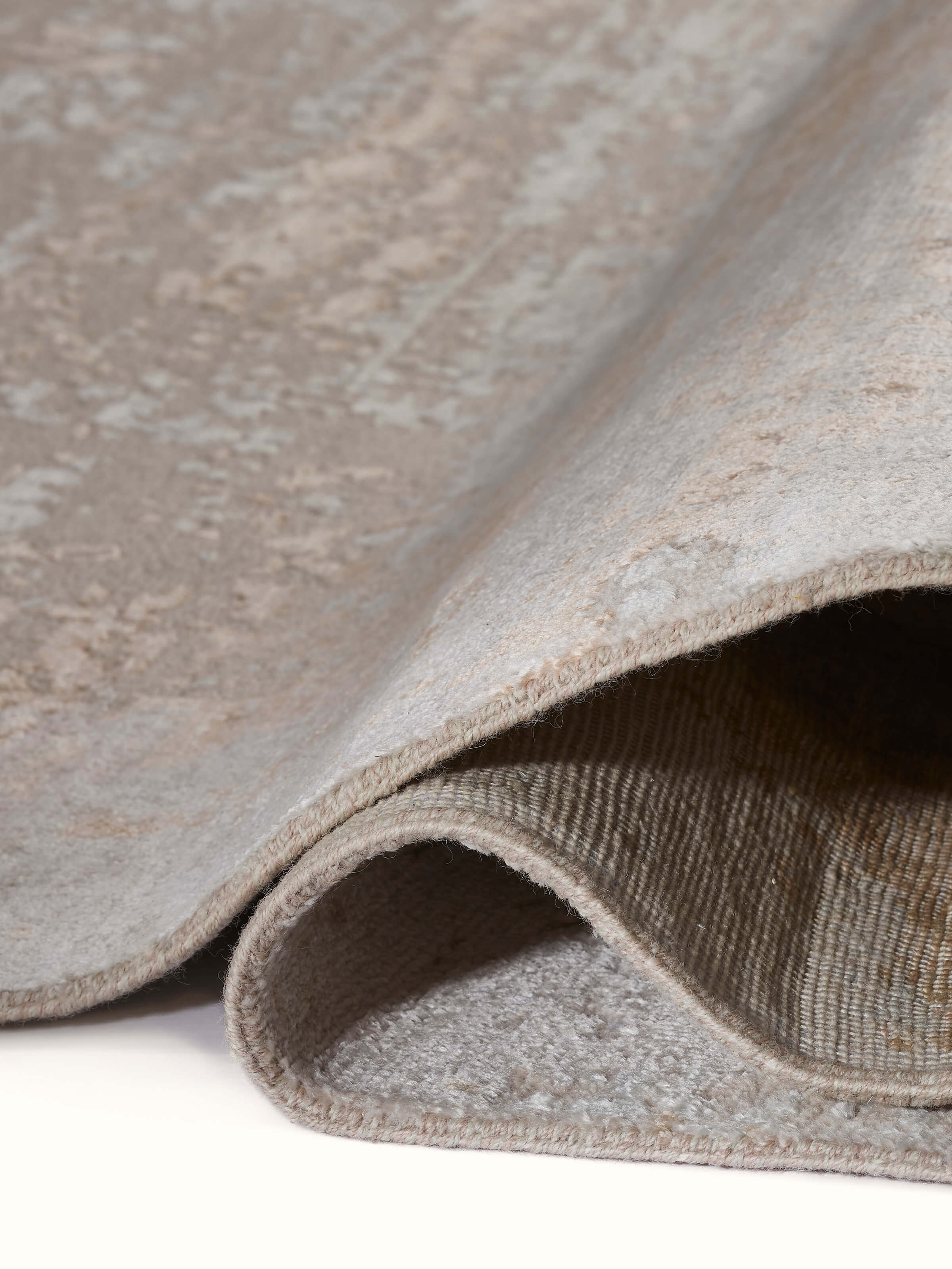 Detail of beige abstract rug showing soft texture and blended wool-viscose craftsmanship