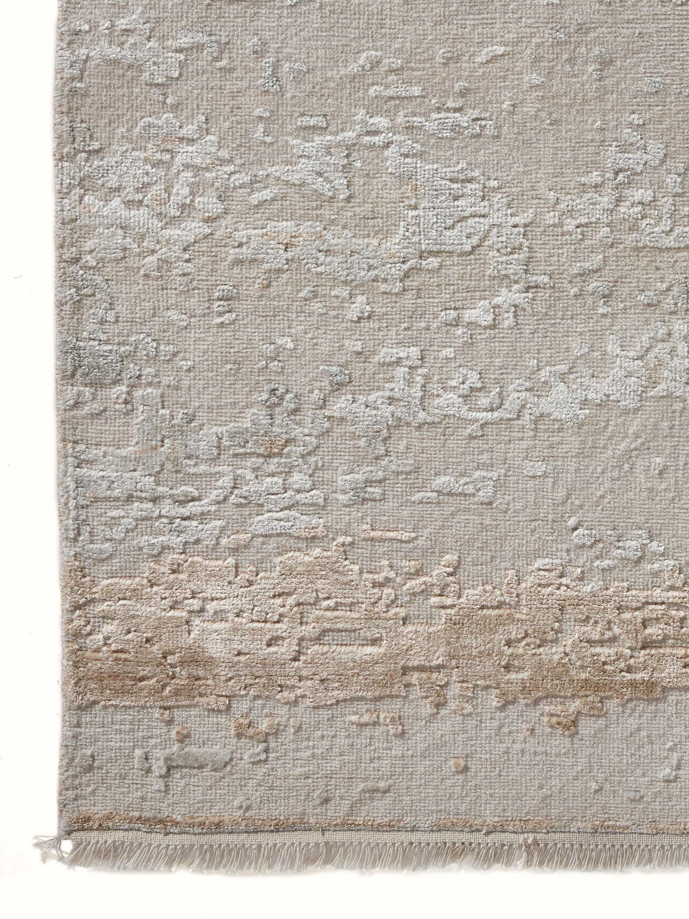 Detailed close-up of abstract grey beige hand-knotted Agra carpet design