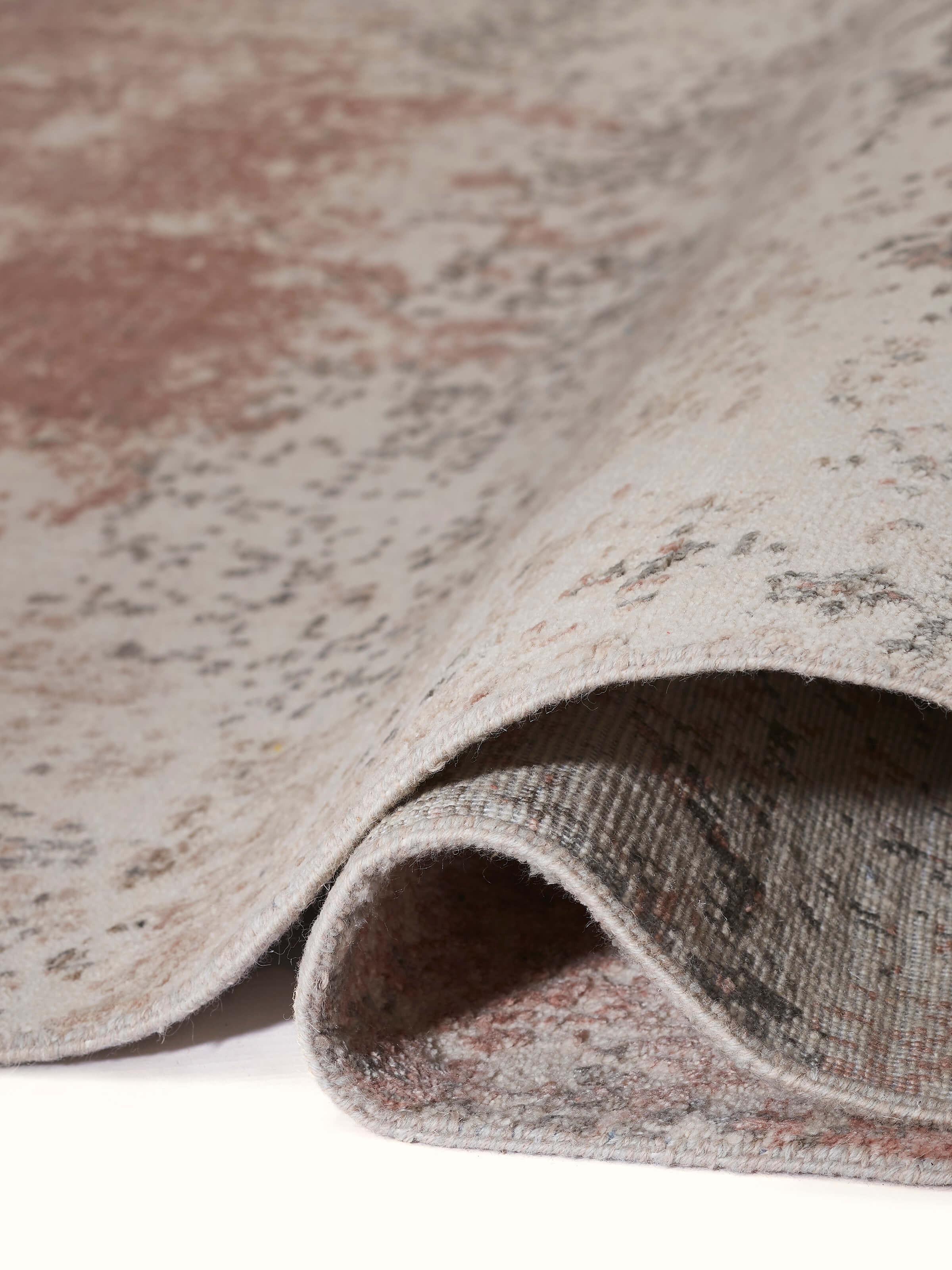 Close-up of modern abstract weave in peach and grey on Agra hand-knotted carpet.