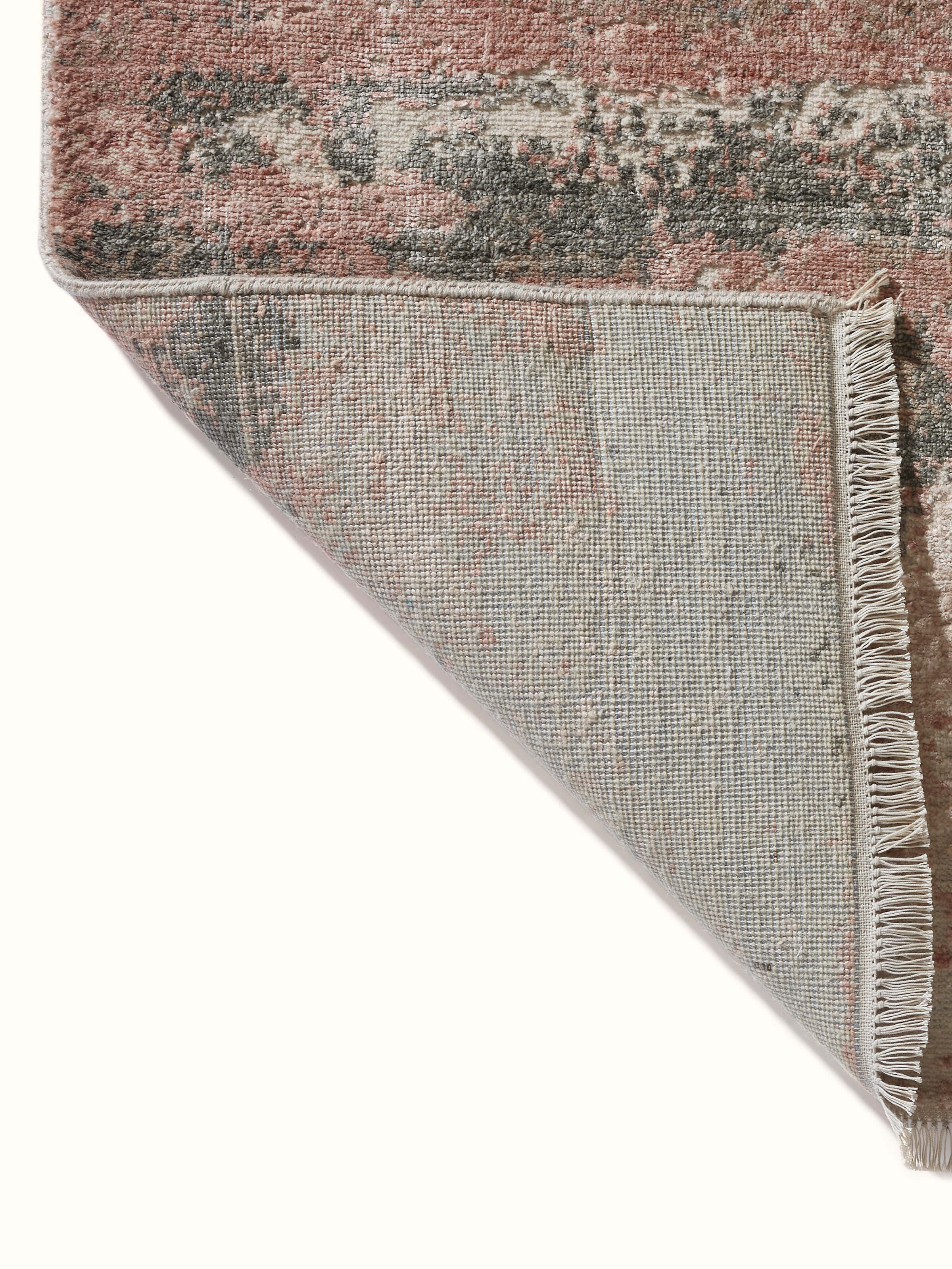 Back view of hand-knotted carpet revealing quality and fine weave texture.