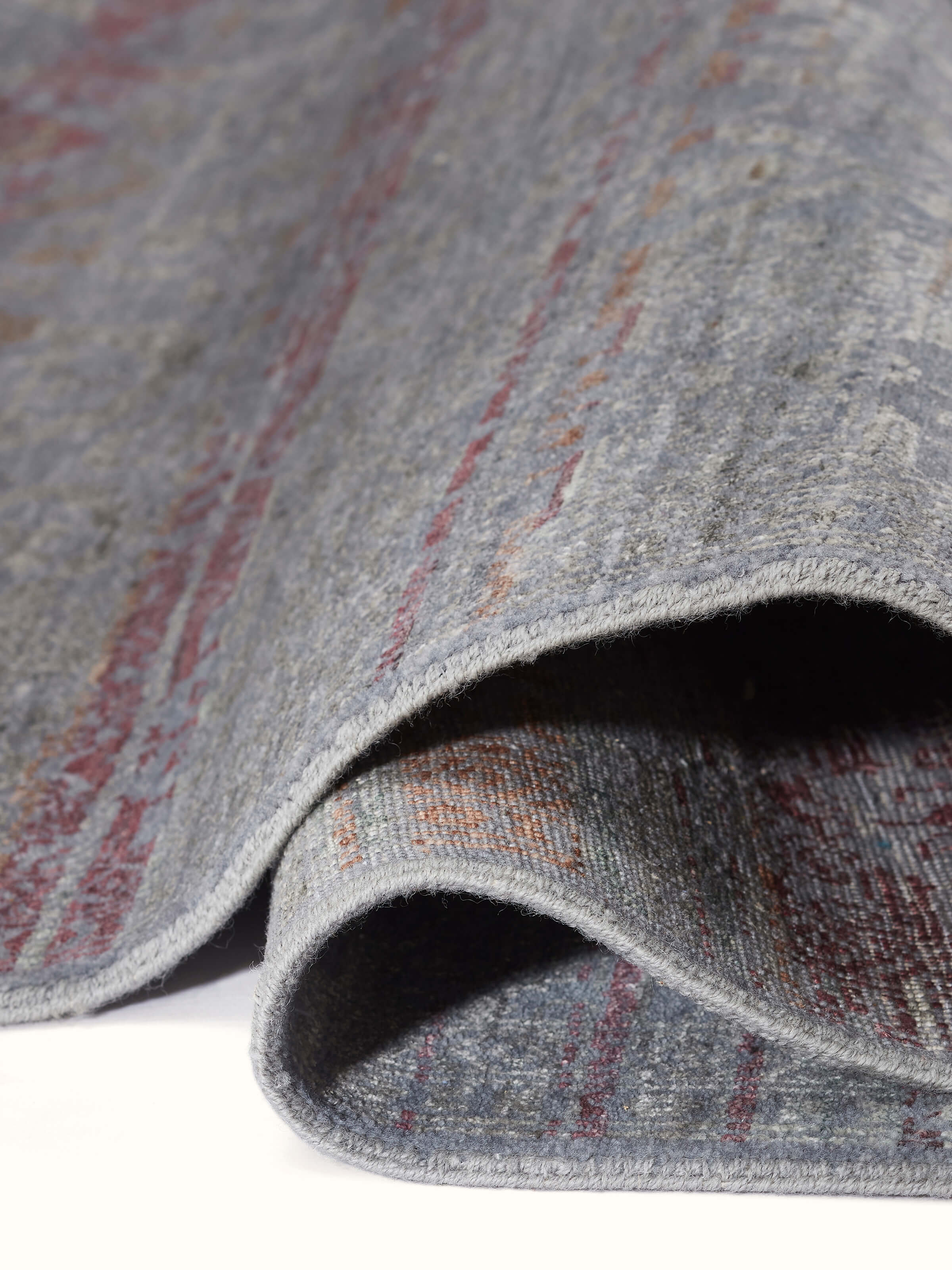 Detailed view highlighting hand-knotted craftsmanship in soft wool-viscose blend.