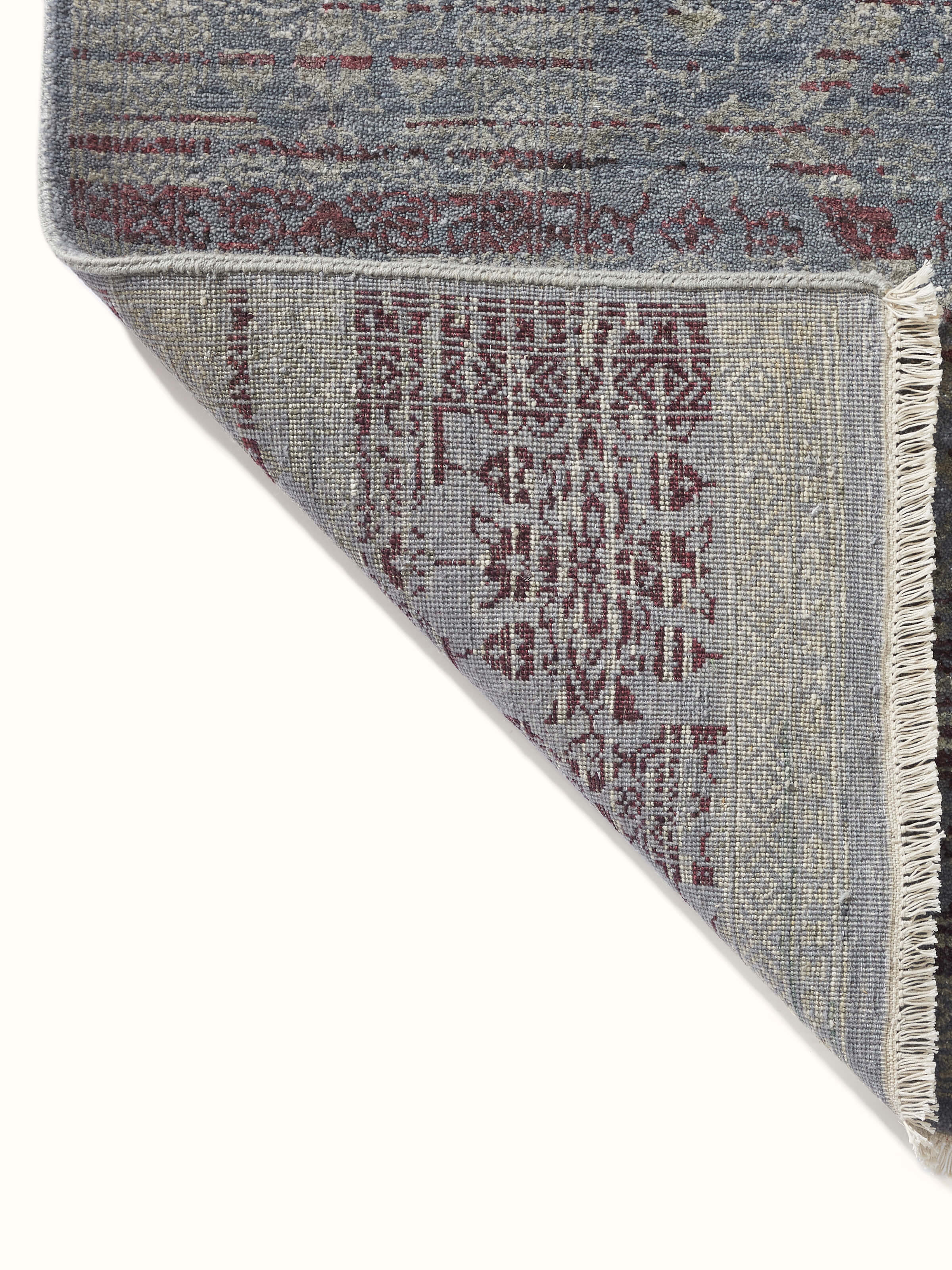 Rear side showing carpet backing and traditional hand-knot detailing.