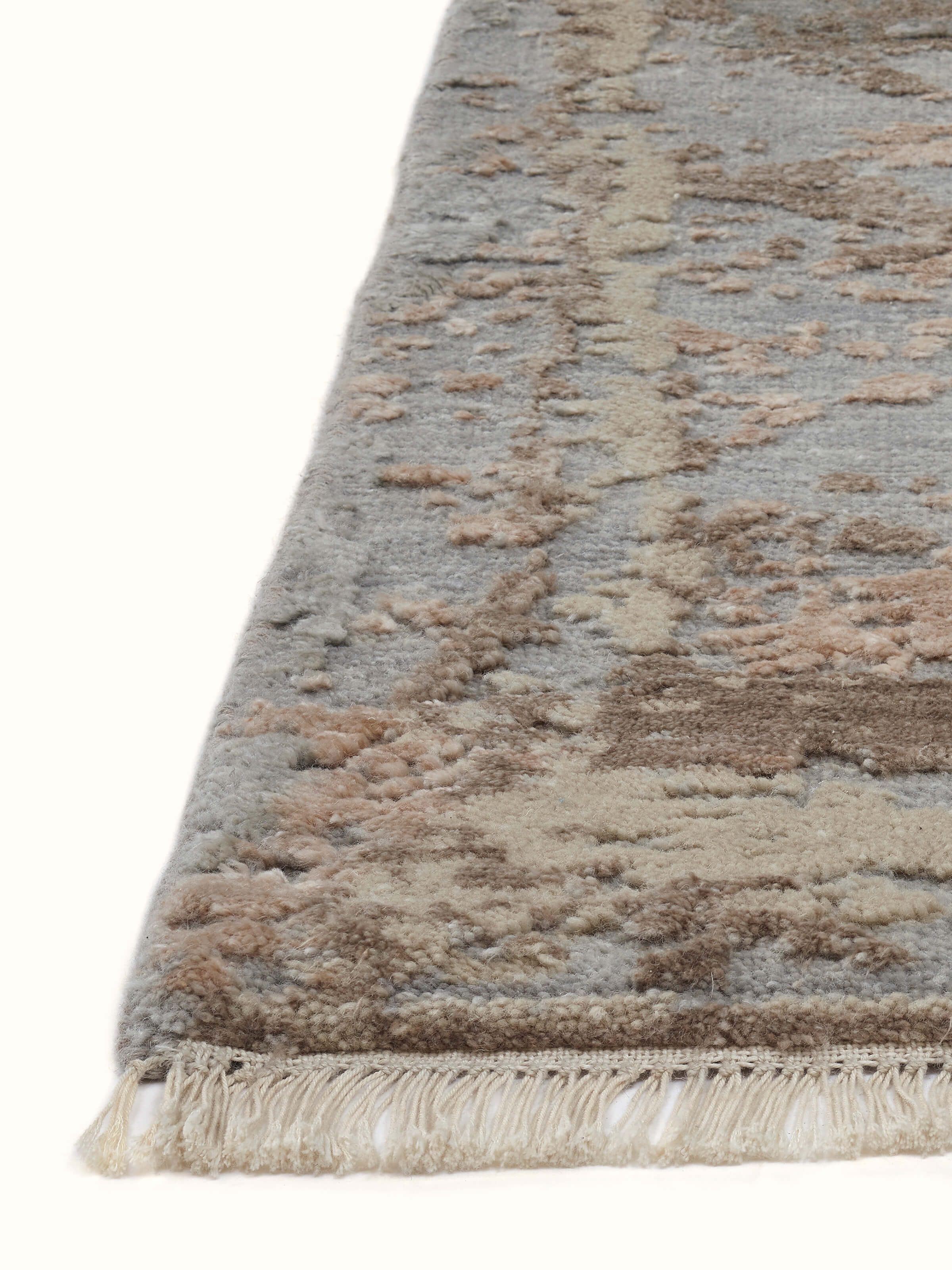 Close-up of Abstract modern grey blush wool & viscose hand-knotted carpet emphasizing texture and color detail