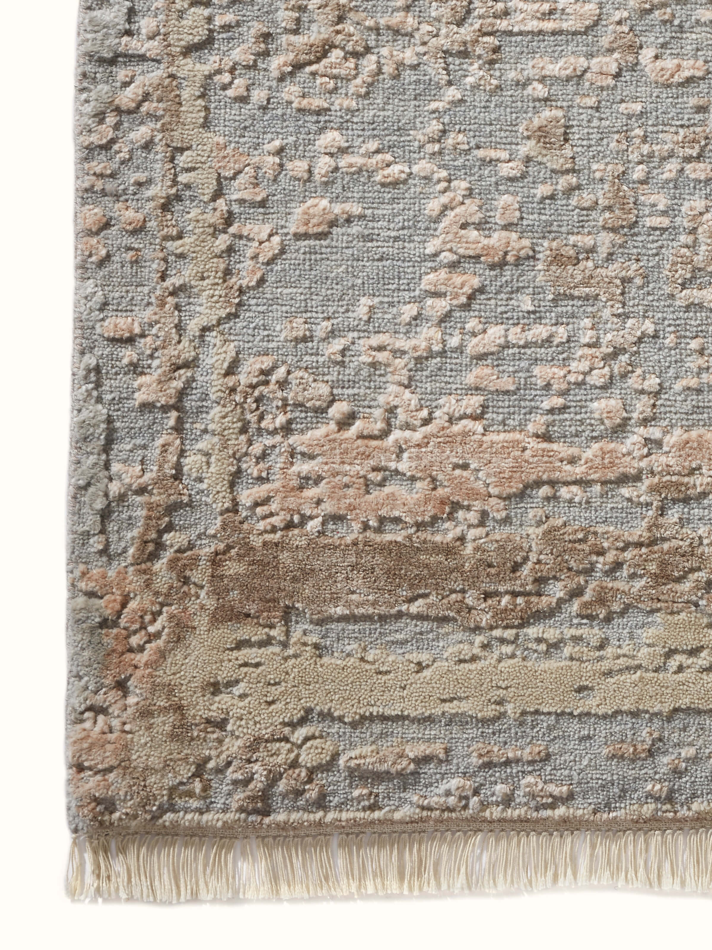 Angle view of Abstract modern grey blush wool & viscose hand-knotted carpet highlighting depth and design nuances