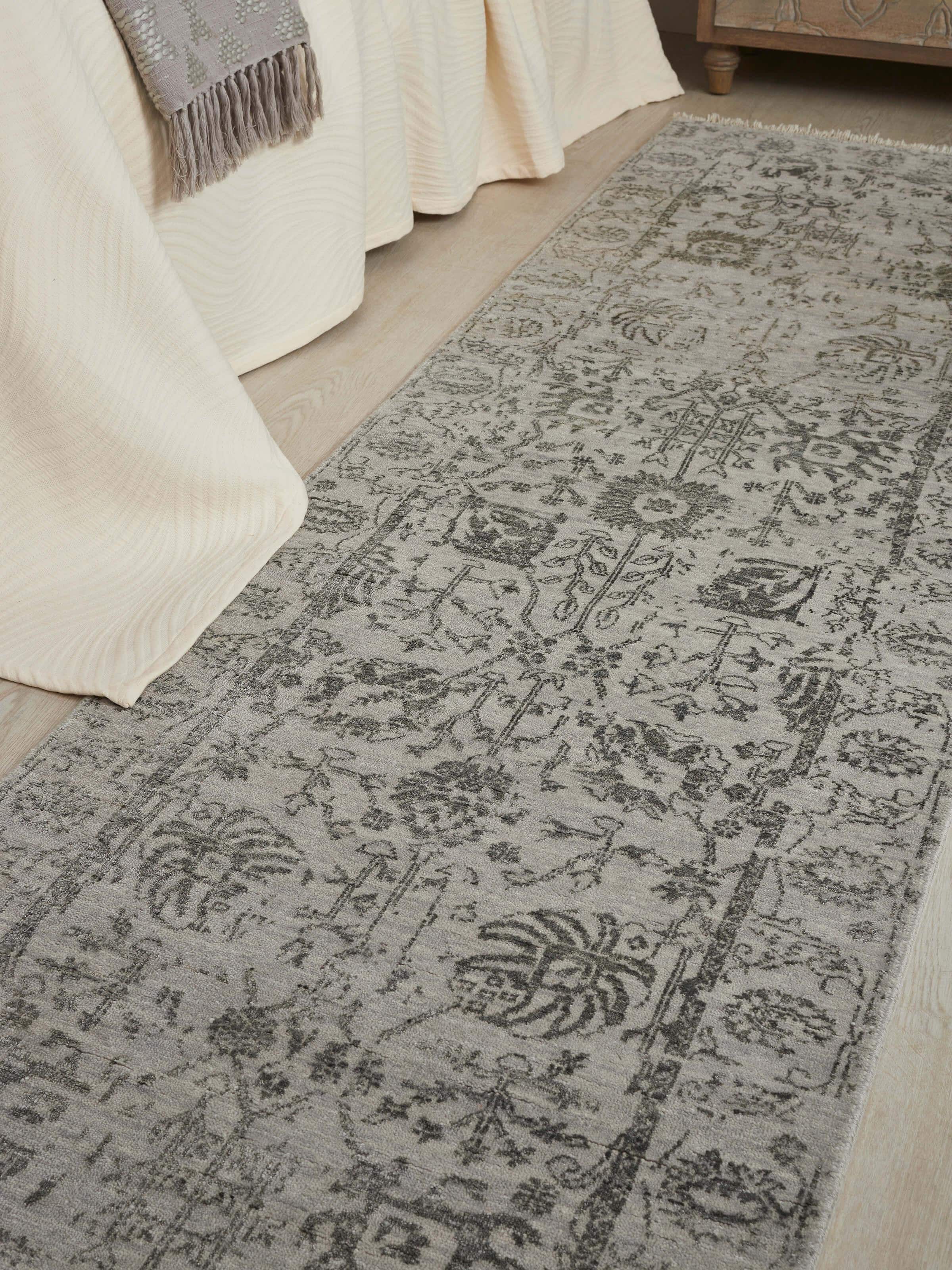 Close-up view of distressed transitional grey charcoal Agra wool & viscose hand-knotted runner.
