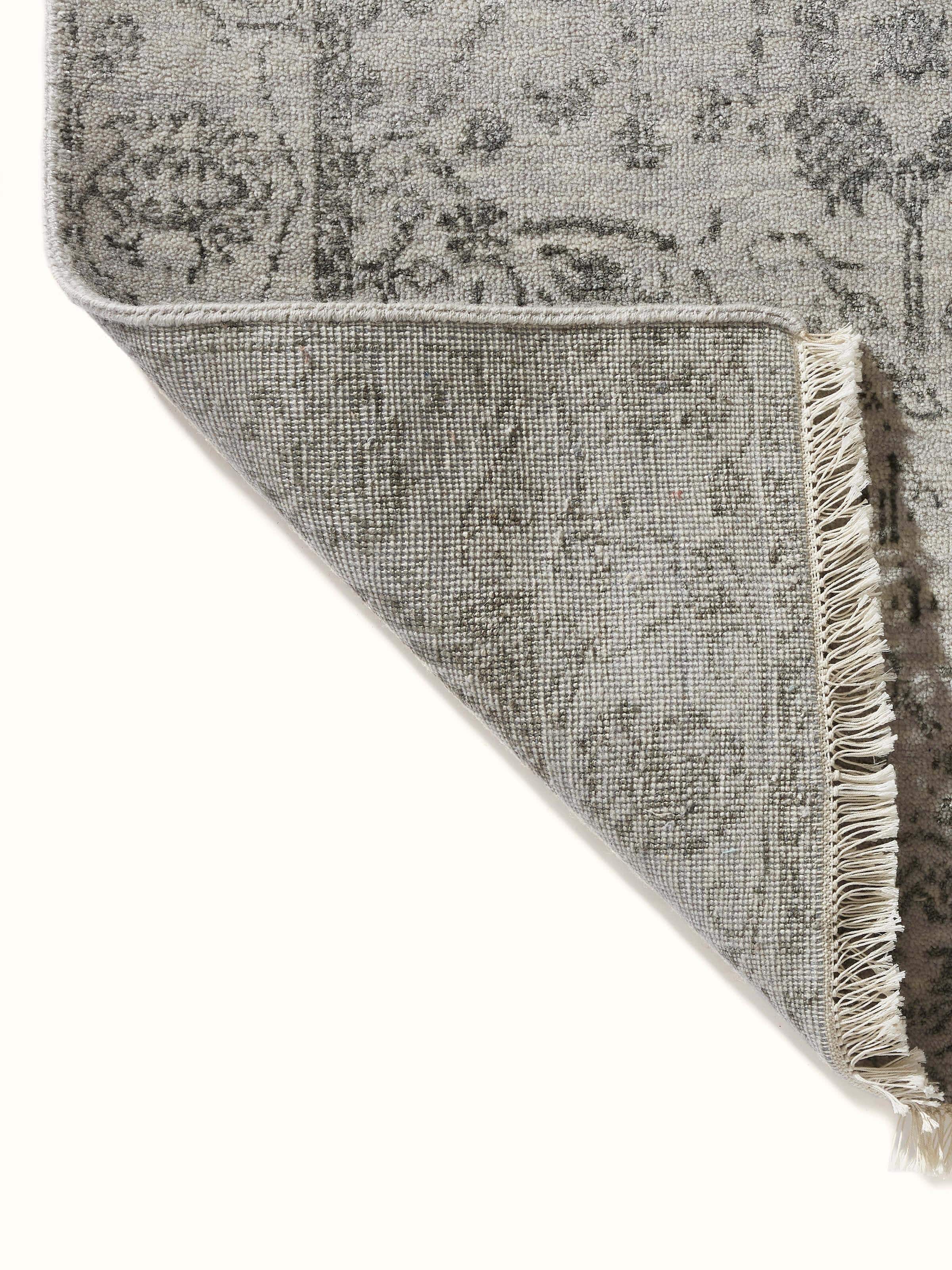 Detailed look at distressed transitional grey charcoal Agra wool & viscose hand-knotted runner's texture.