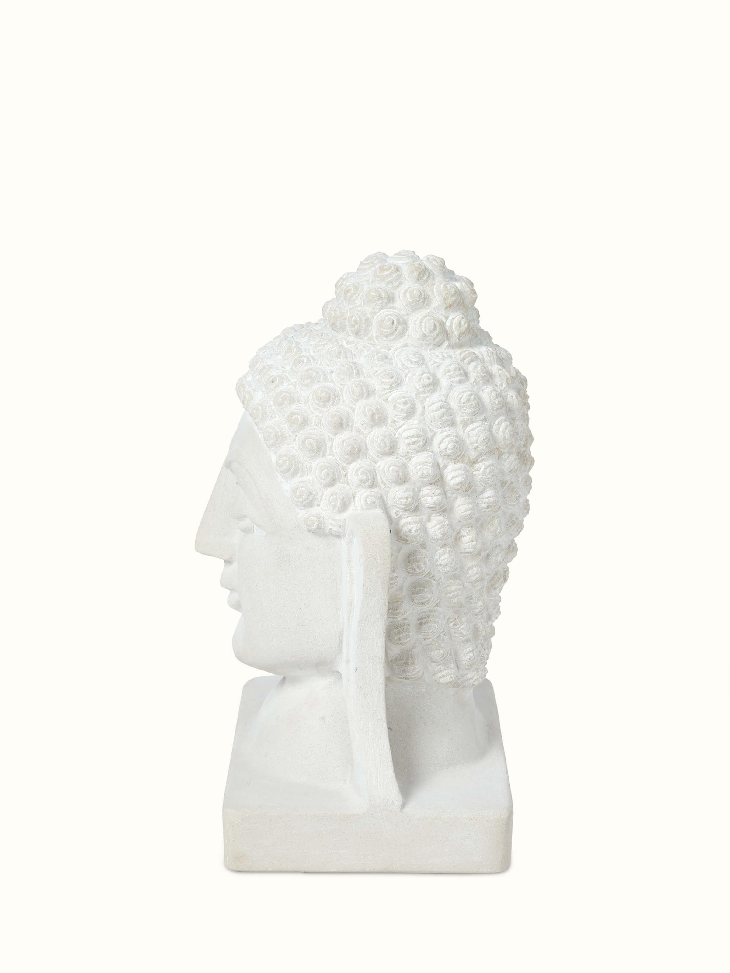 Detailed view of Tranquil Carved Stone Buddha Face Idol focusing on the texture and carving