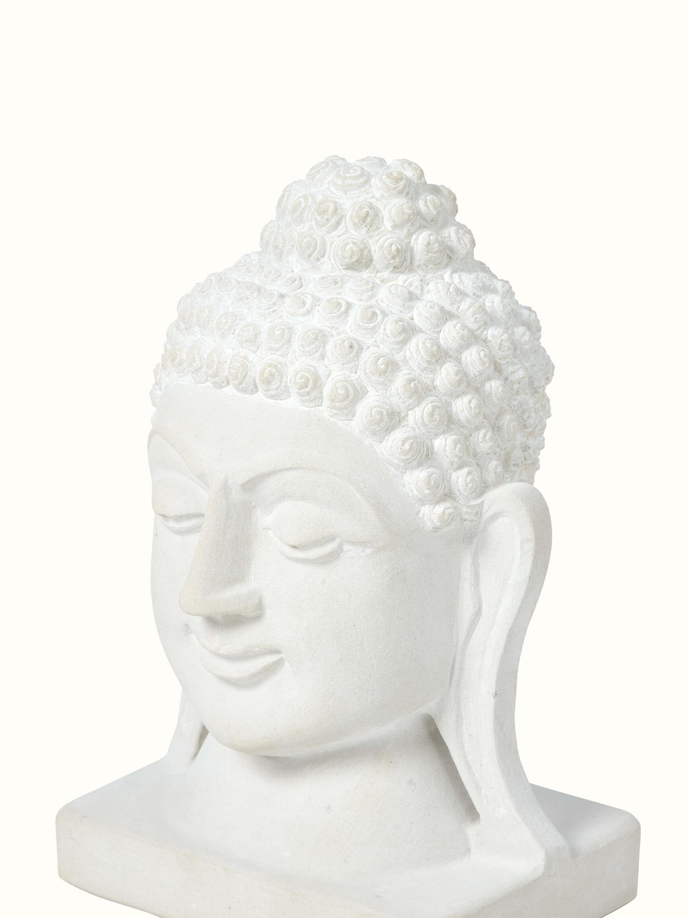 Angle view of Tranquil Carved Stone Buddha Face Idol displaying the serene expression