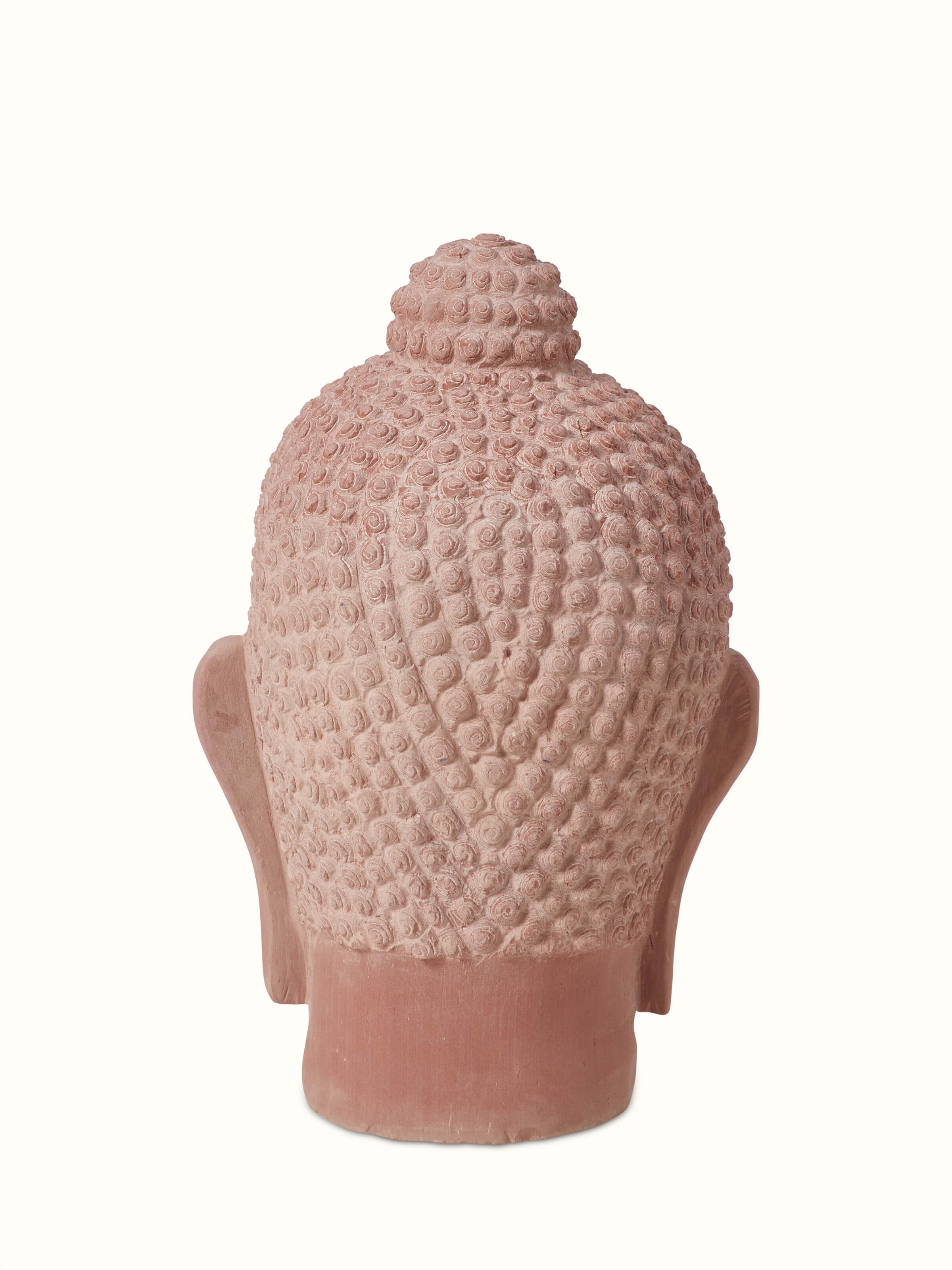 Side view of serene carved stone Buddha face idol, showcasing the depth and texture of the stone carving