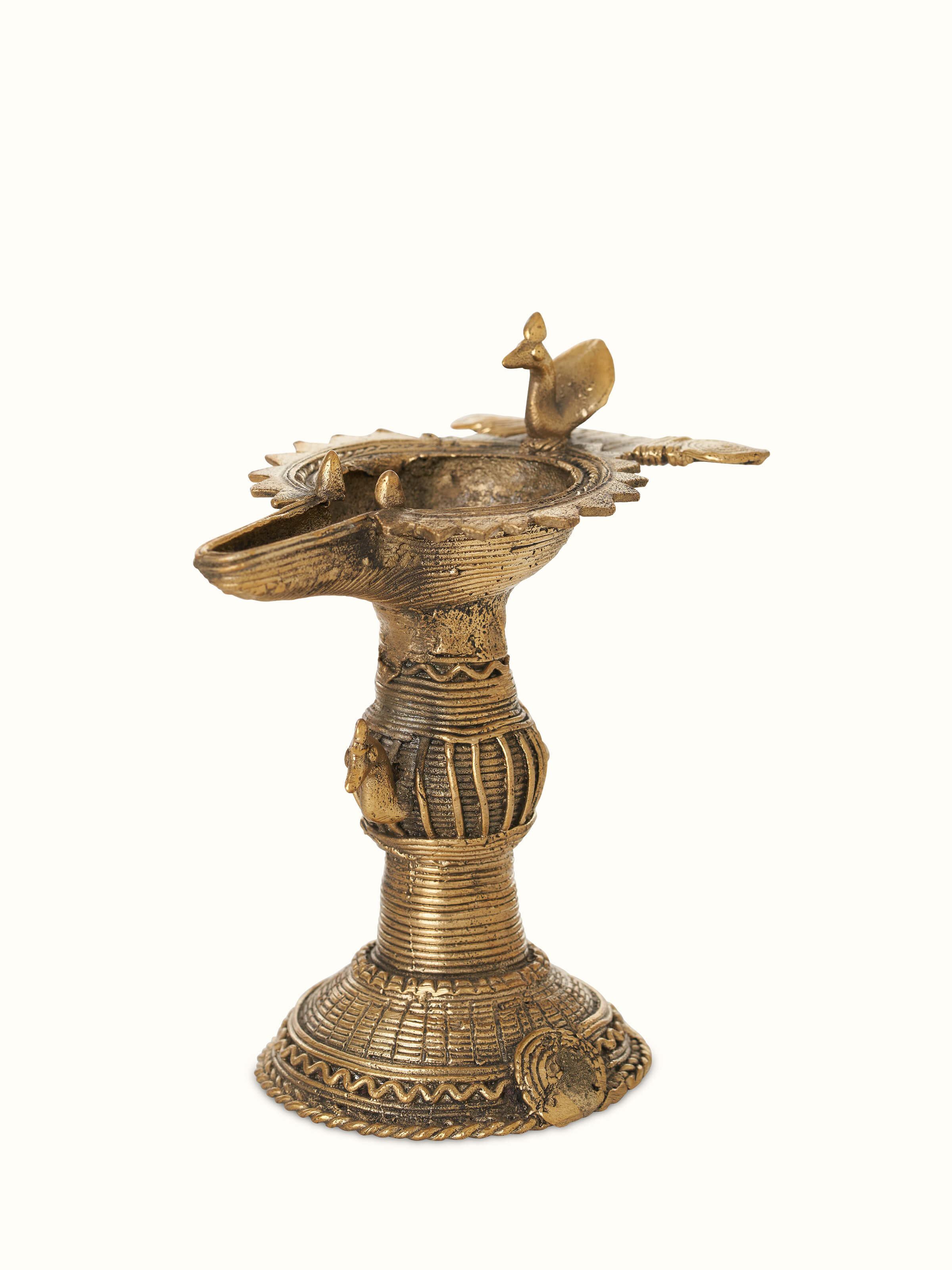 Angled view of Antique brass dhokra diya showcasing its rich texture and traditional artistry
