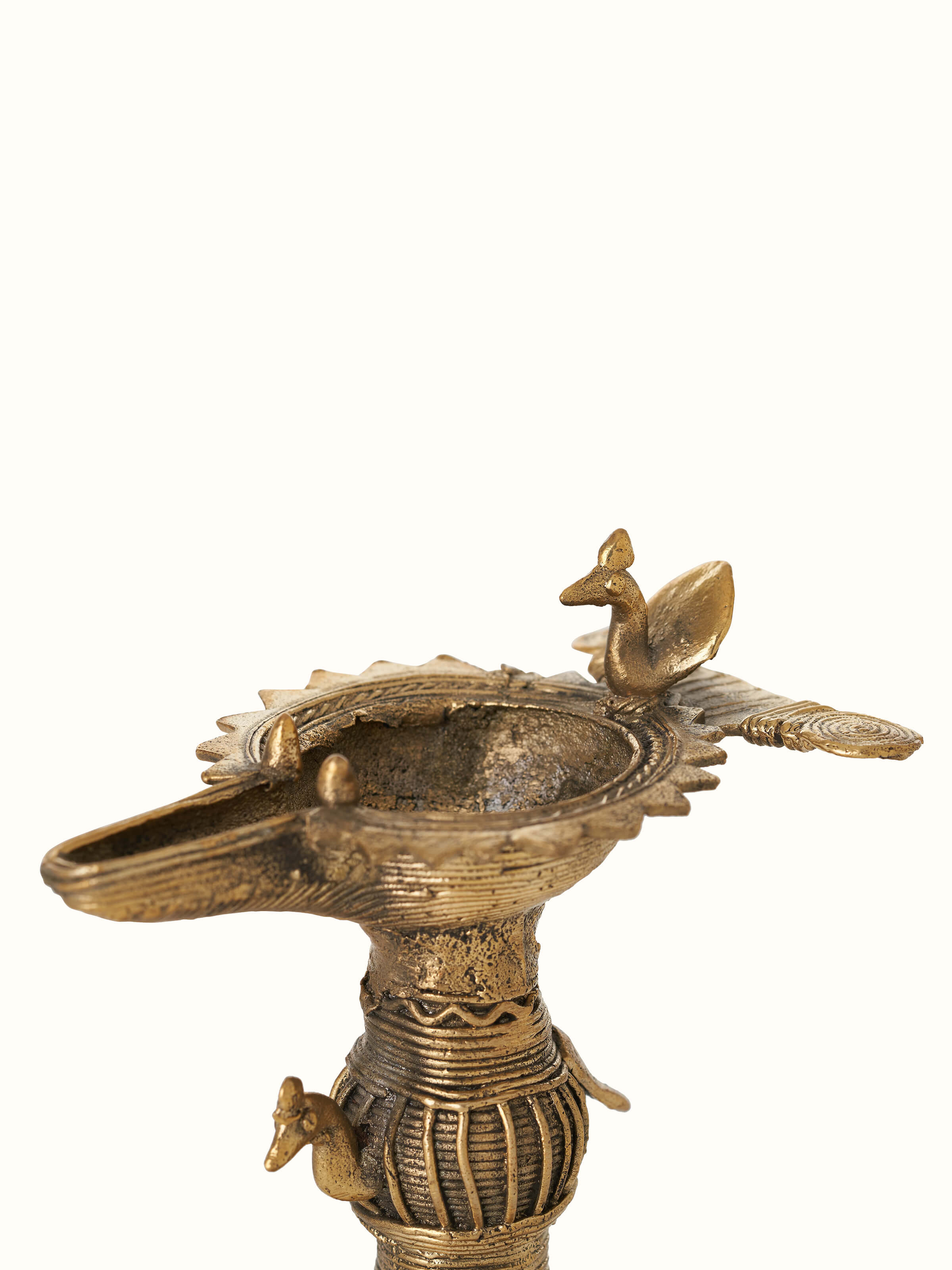 Close-up of Antique brass dhokra diya highlighting its detailed engravings and brass finish