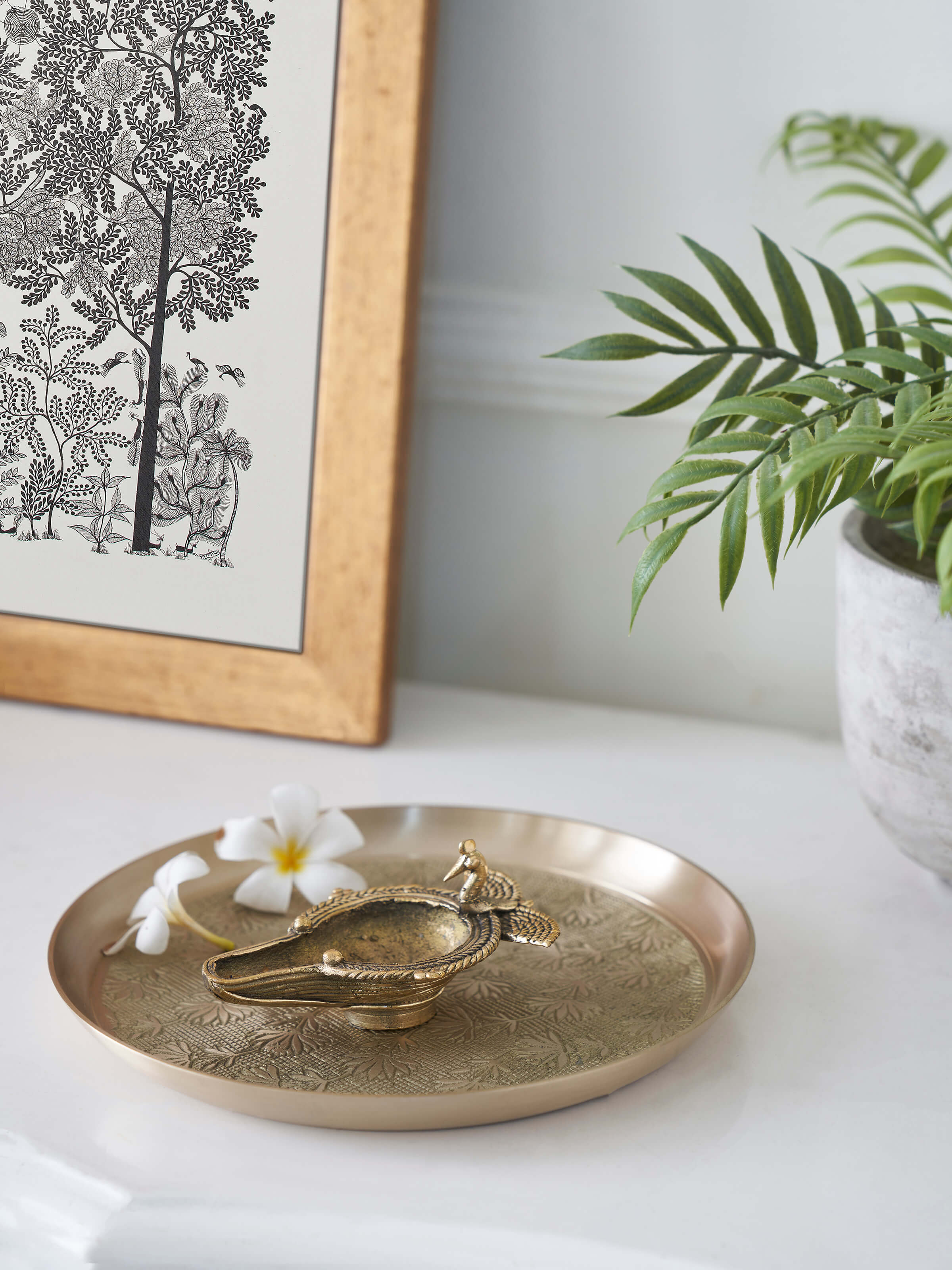 Close-up of the antique brass dhokra peacock diya highlighting its detailed craftsmanship.