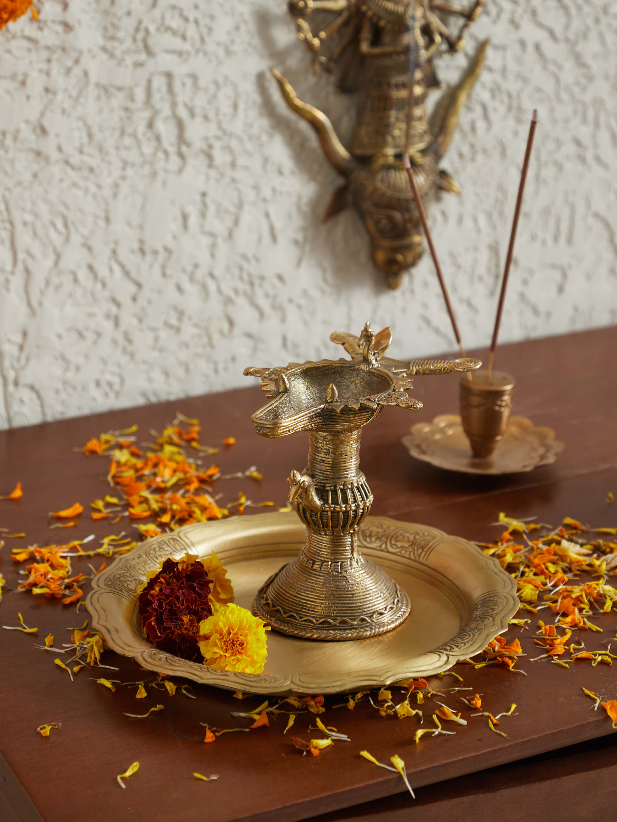 Side view of antique brass dhokra diya, highlighting its elegant craftsmanship and antique finish