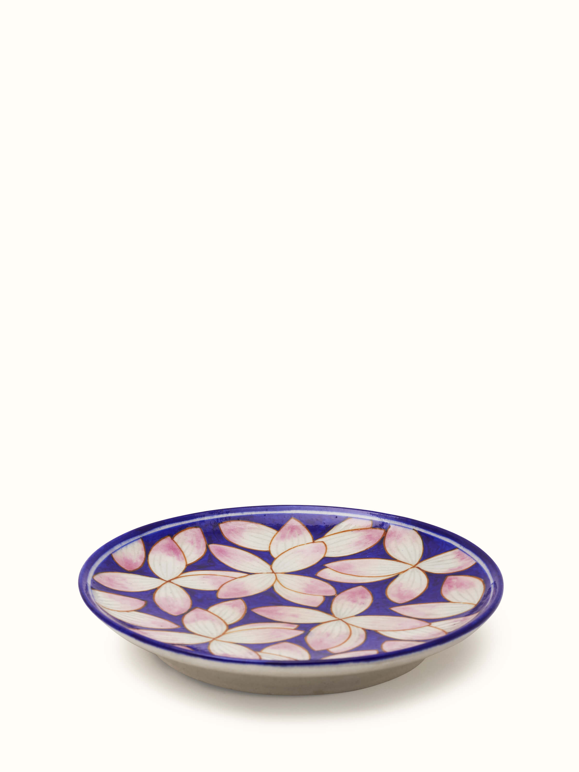 Top view of blue pottery petals display plate showcasing its decorative design.