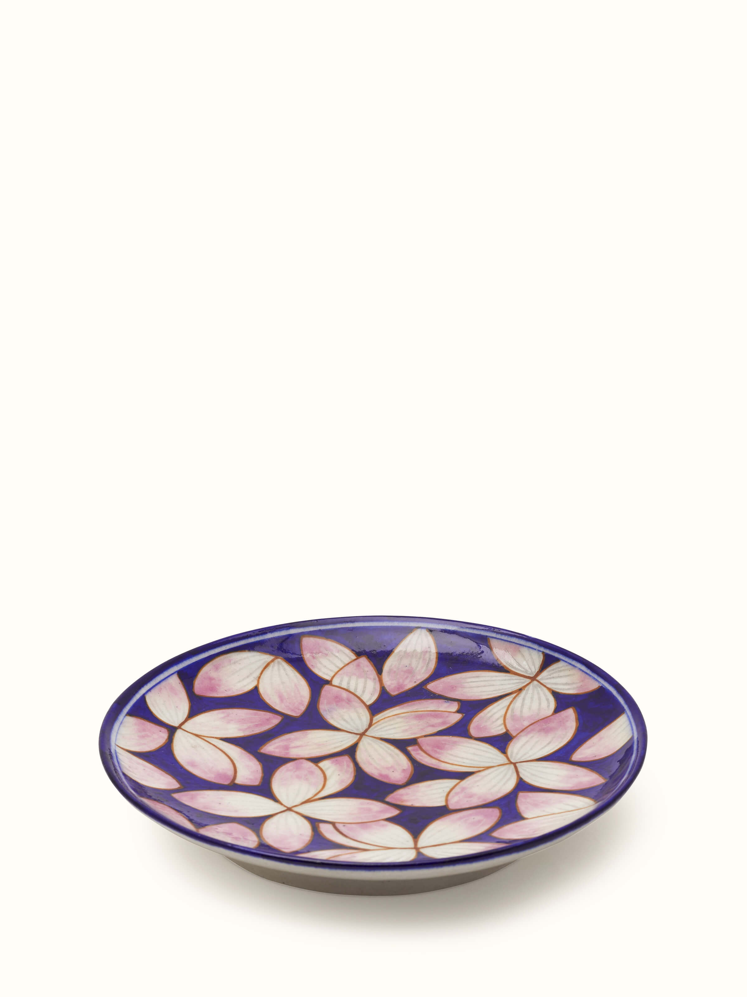 Close-up view of blue pottery petals display plate with detailed blue patterns.