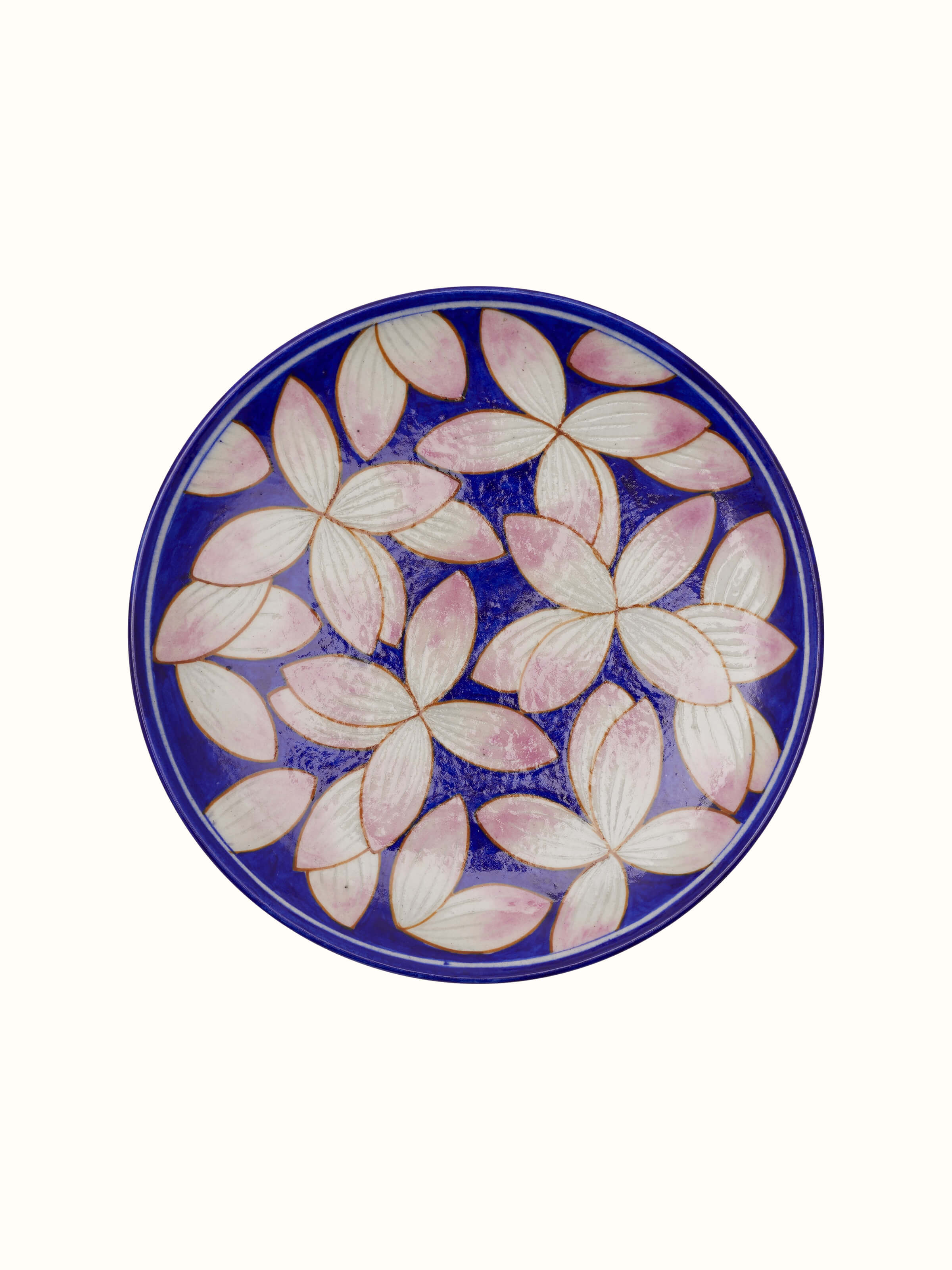 Side view of blue pottery petals display plate highlighting its elegant shape.