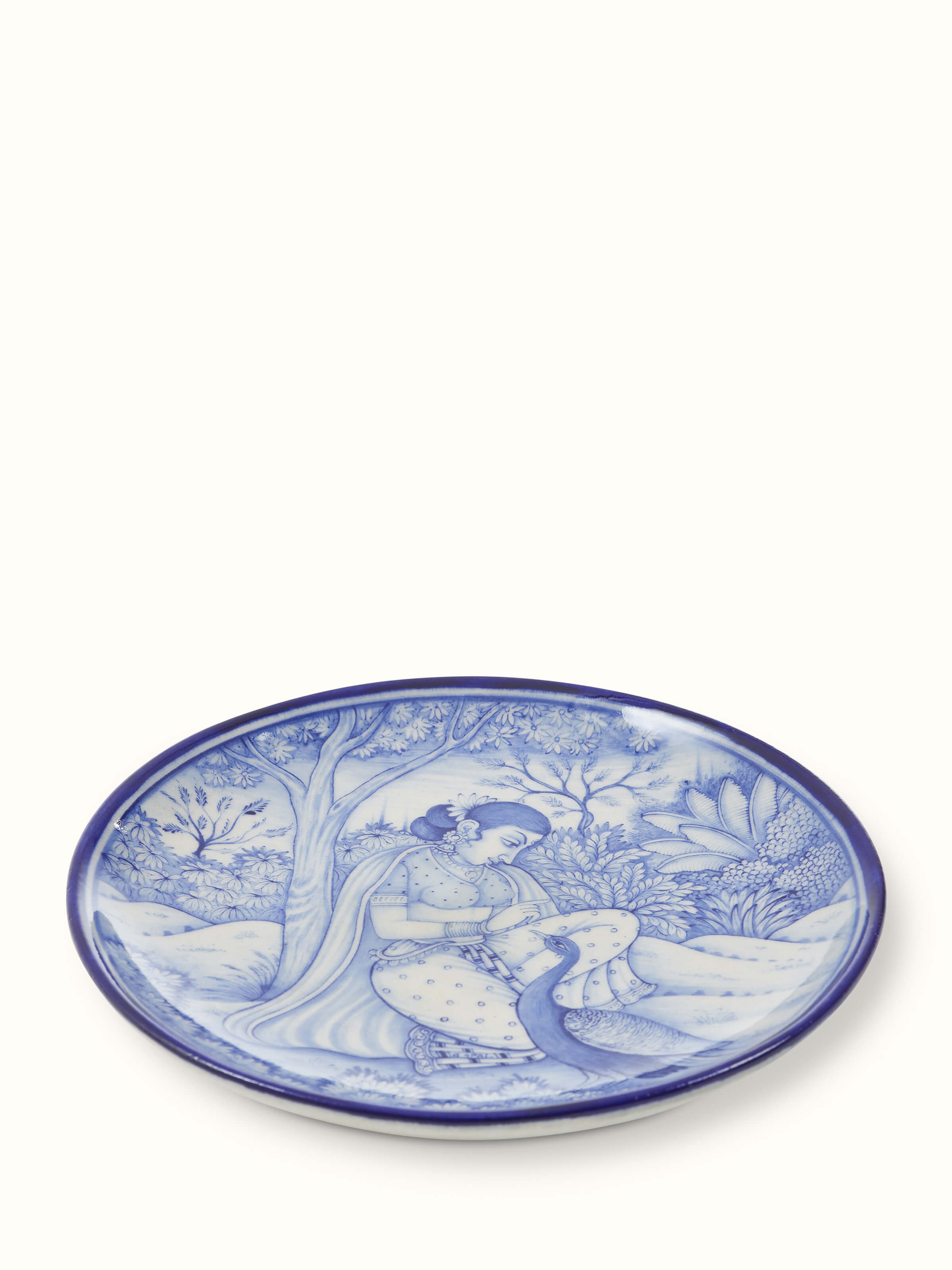 Detailed view of Blue Pottery Woman under Tree Display Plate by Swadesh emphasizing the beautiful hand-painted design and intricate details.