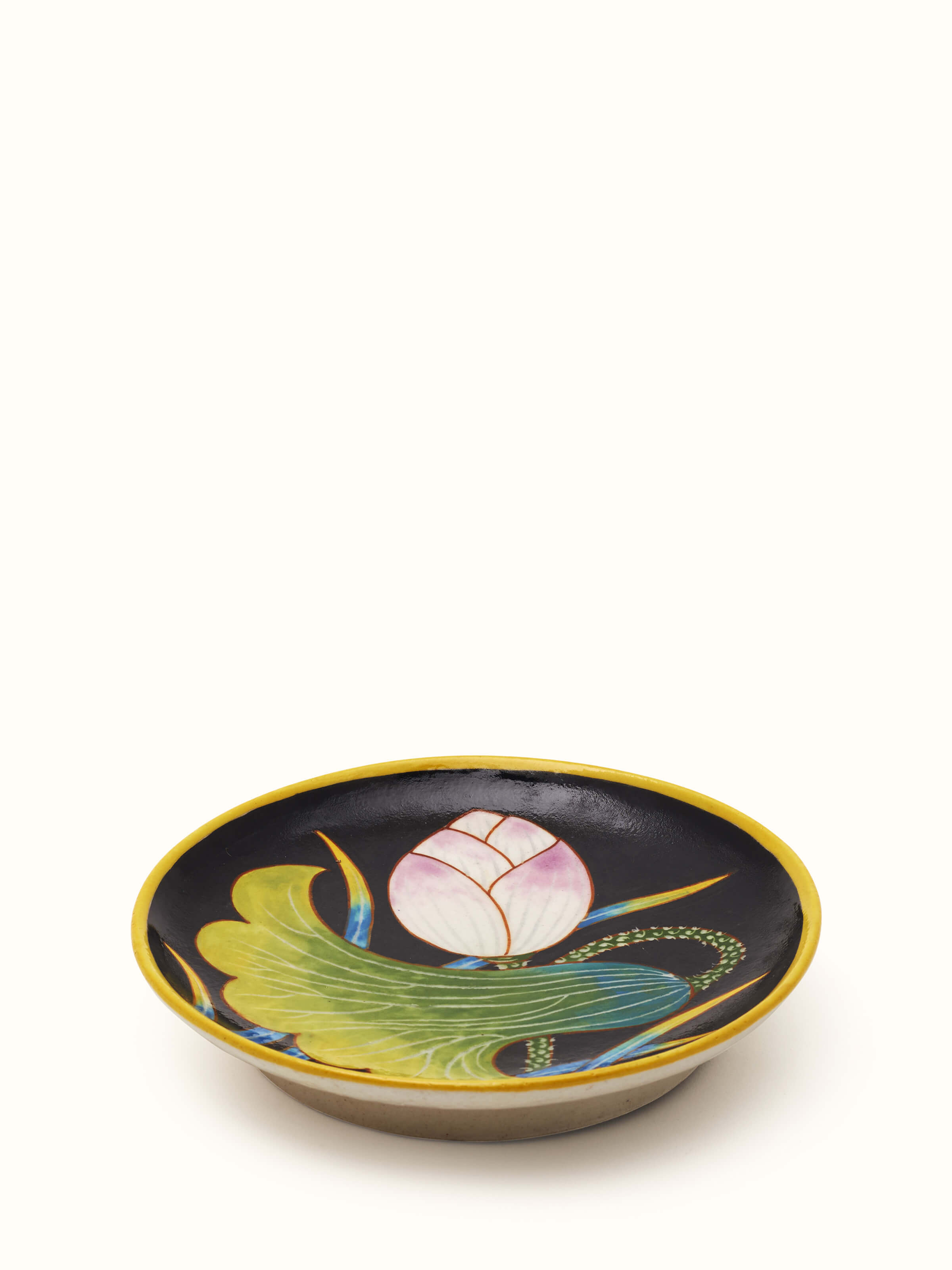 Angled view of Blue pottery black flower display plate emphasizing the intricate black flower patterns and quality craftsmanship