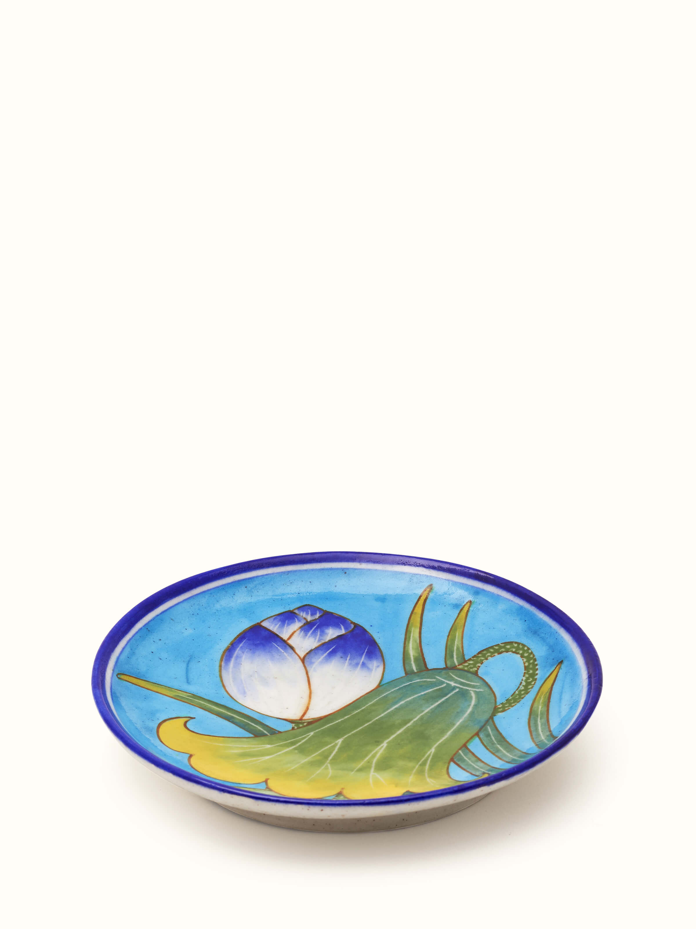 Side view of blue pottery floral display plate, highlighting the depth and vibrant colors of the design.