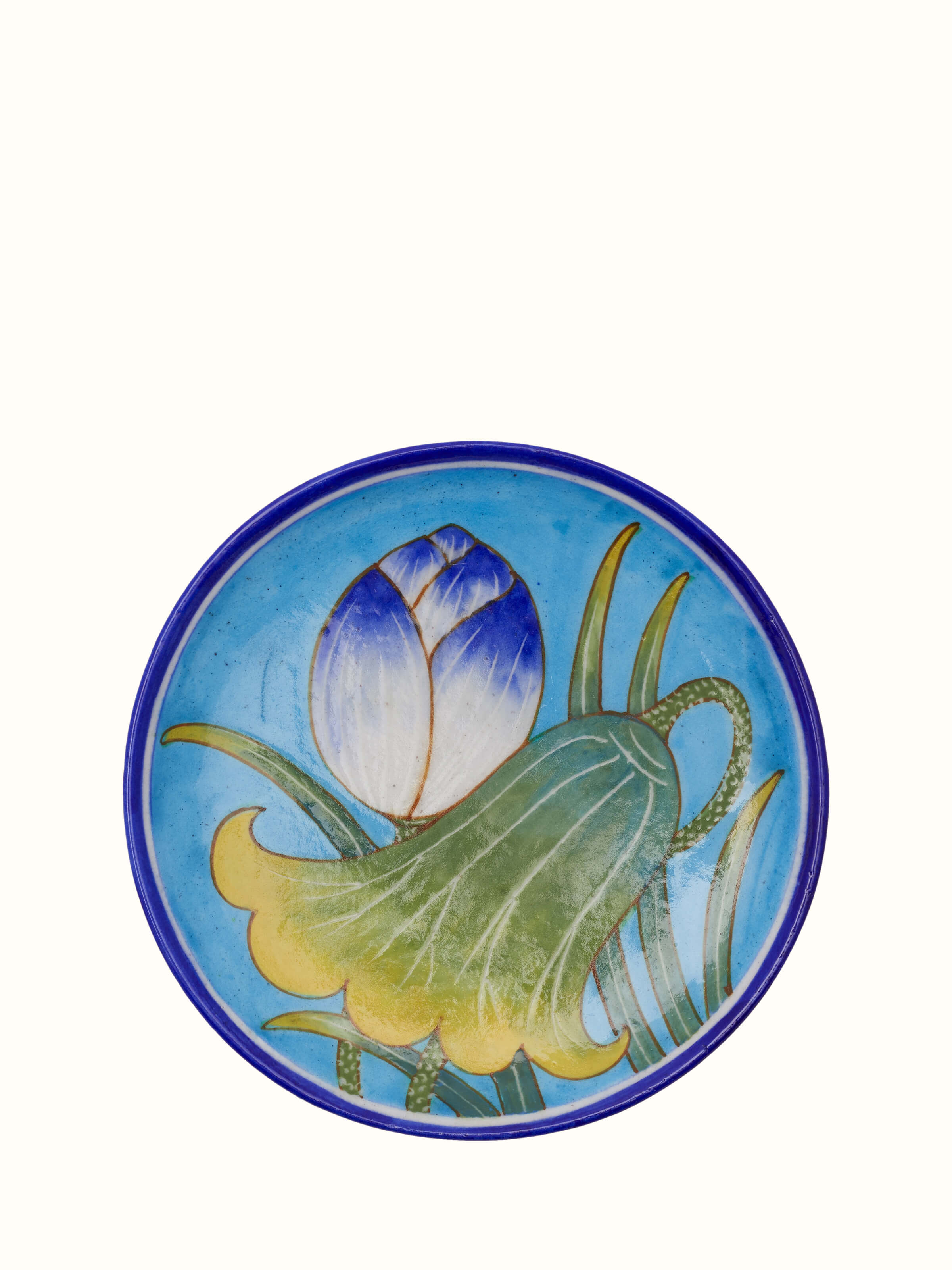 Angled view of blue pottery floral display plate, showing the intricate floral pattern and smooth glaze.