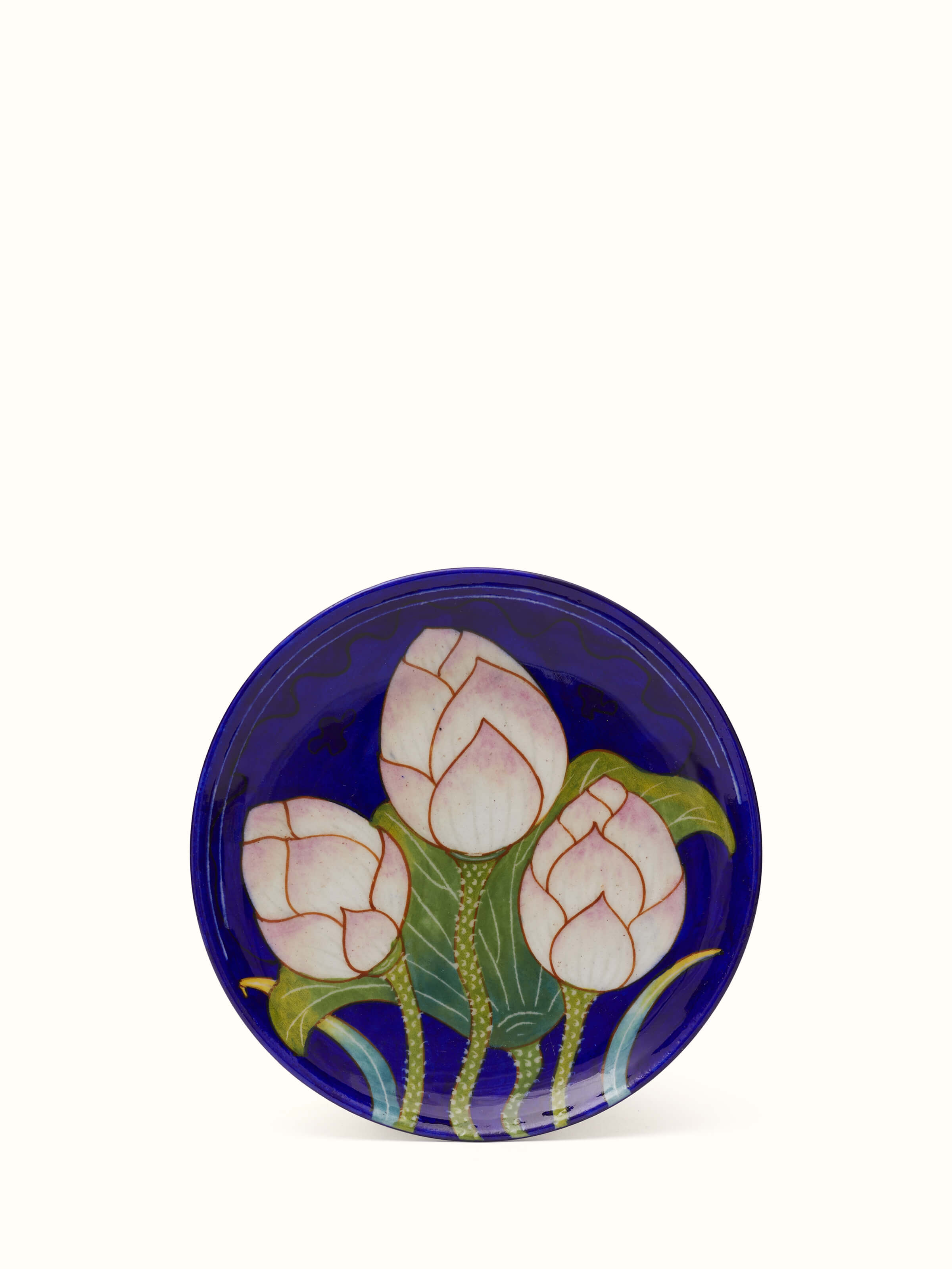 Side view of Blue Pottery Three Flowers Display Plate from Swadesh, showcasing vibrant floral designs and delicate ceramic craftsmanship.