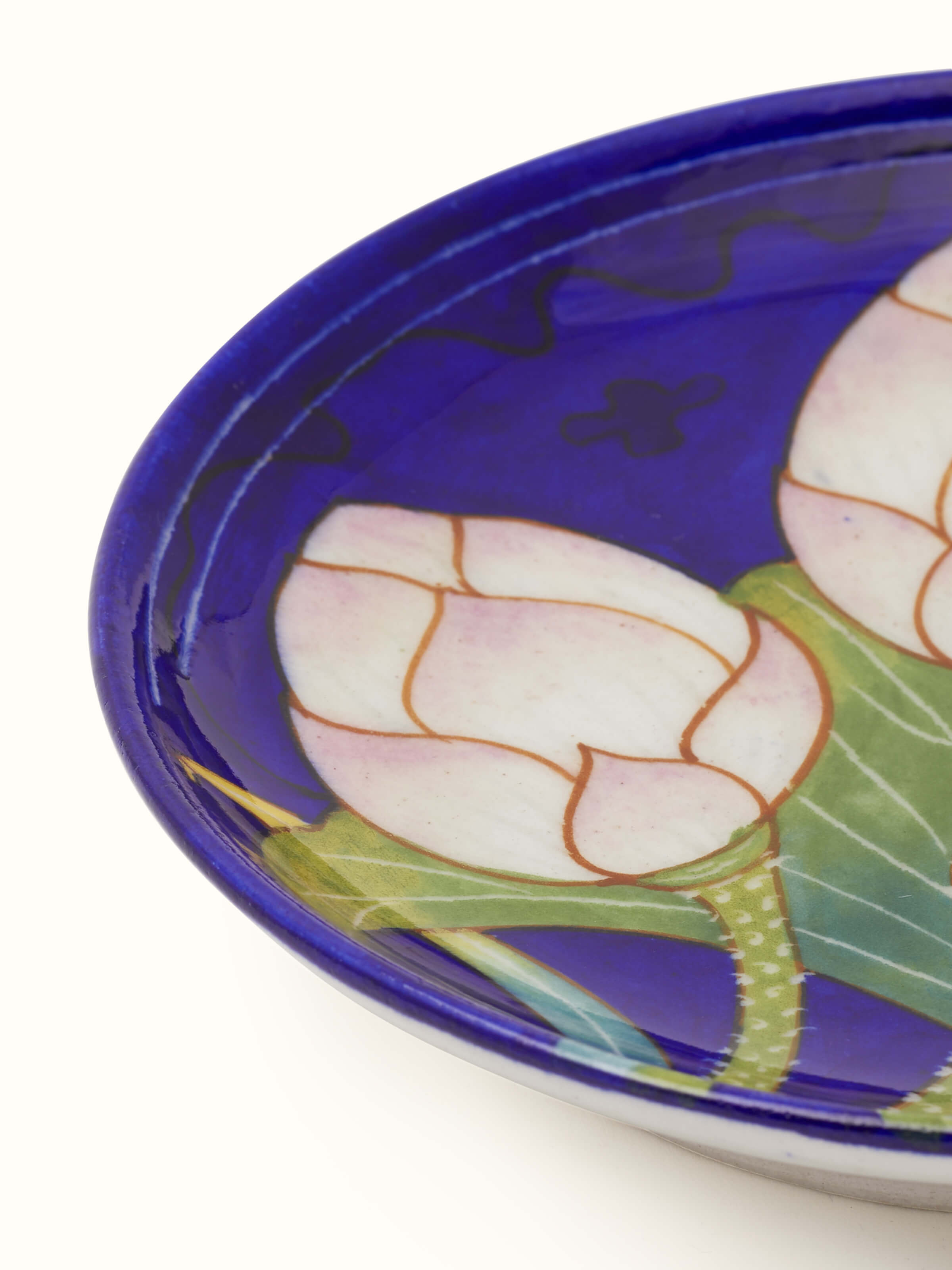 Back view of Blue Pottery Three Flowers Display Plate from Swadesh, highlighting the ceramic texture and vibrant flower designs.