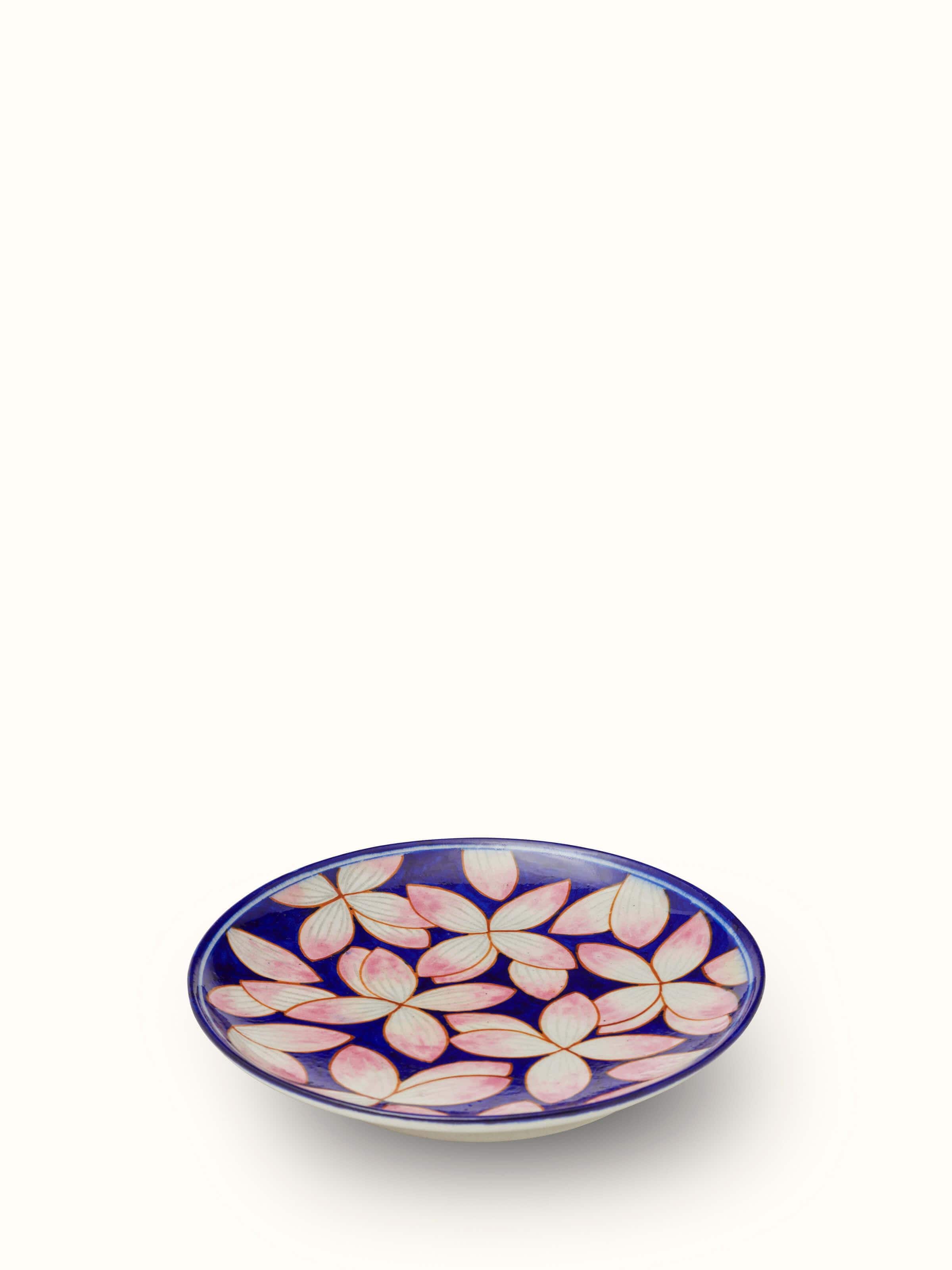 Close-up of Blue Pottery Contemporary Flower Display Plate showing detailed flower designs and the texture of the pottery