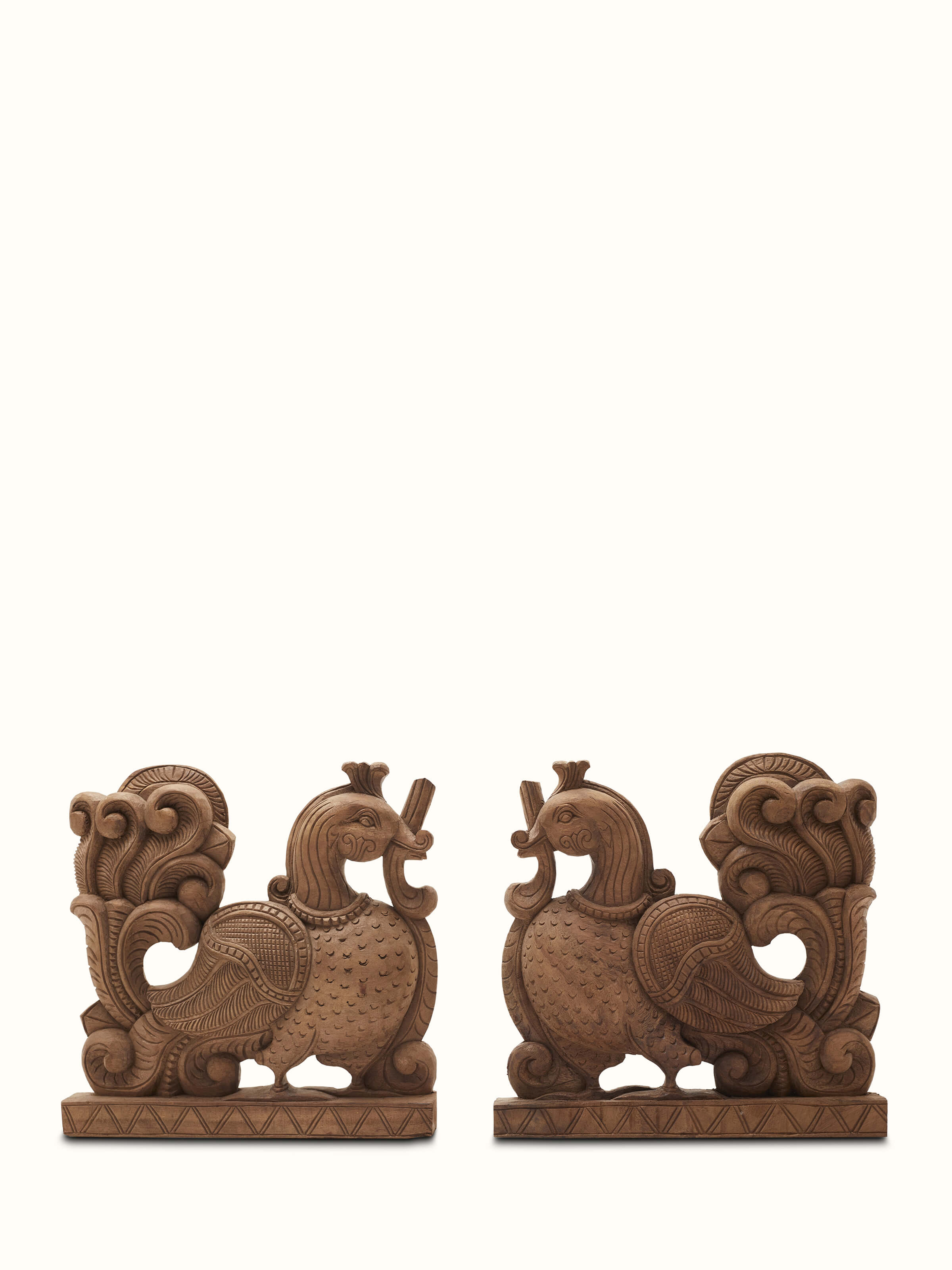 Carved neem wood parrot brackets sculpture with intricate detailing and vibrant colors.
