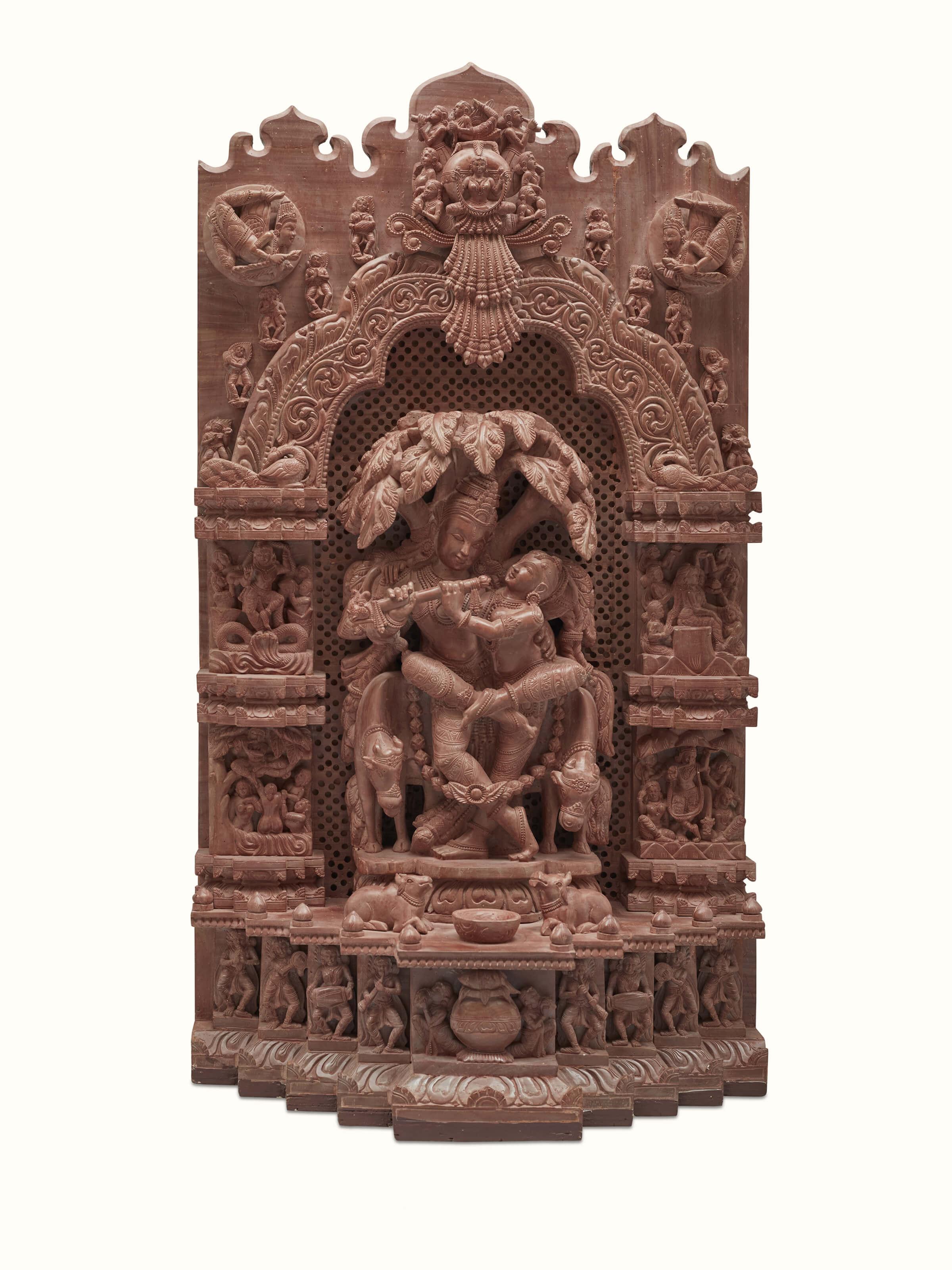 Front view of carved stone Radha & Krishna raasa idol with detailed artistry.