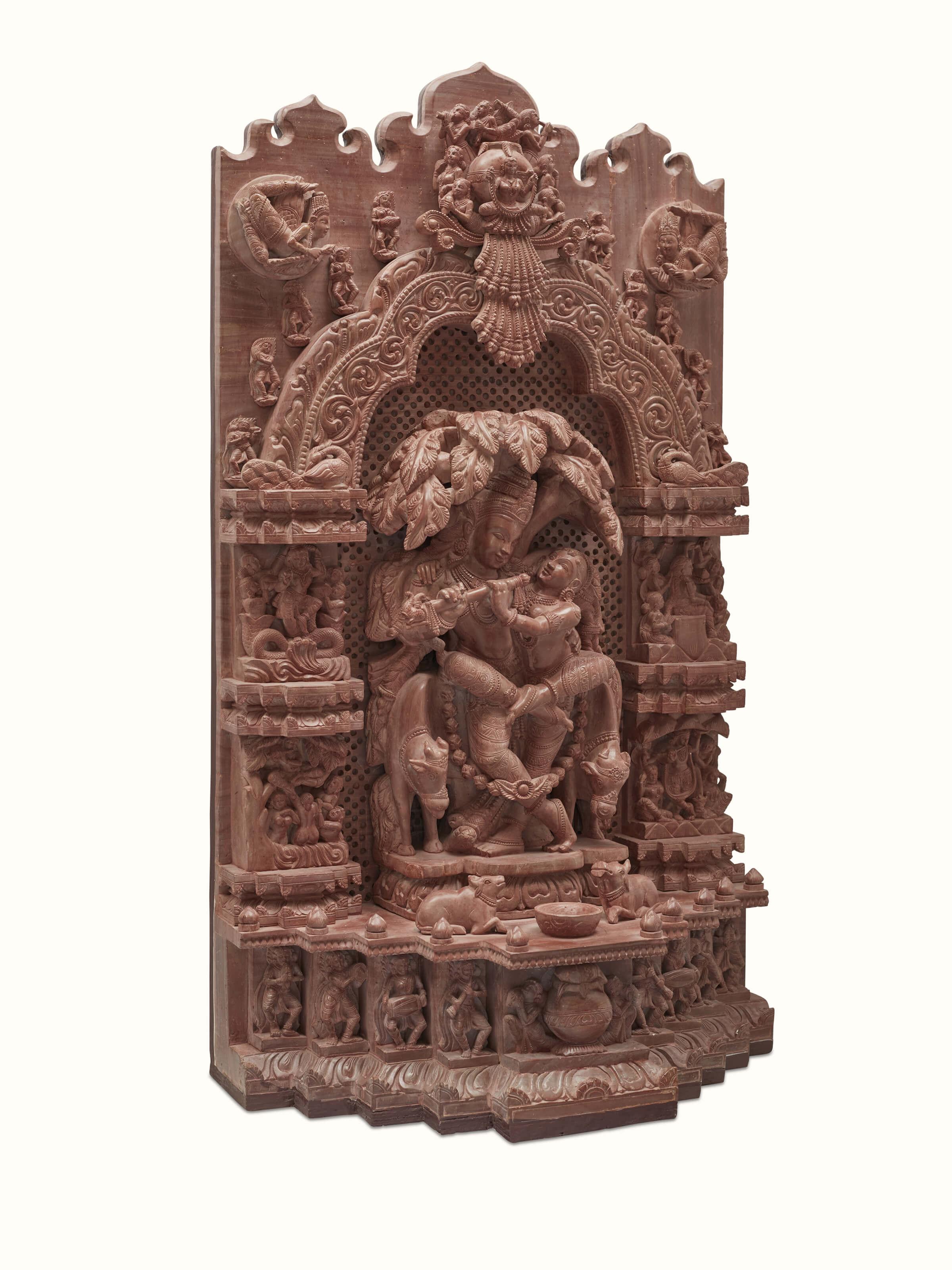 Side view of carved stone Radha & Krishna raasa idol highlighting intricate carvings.