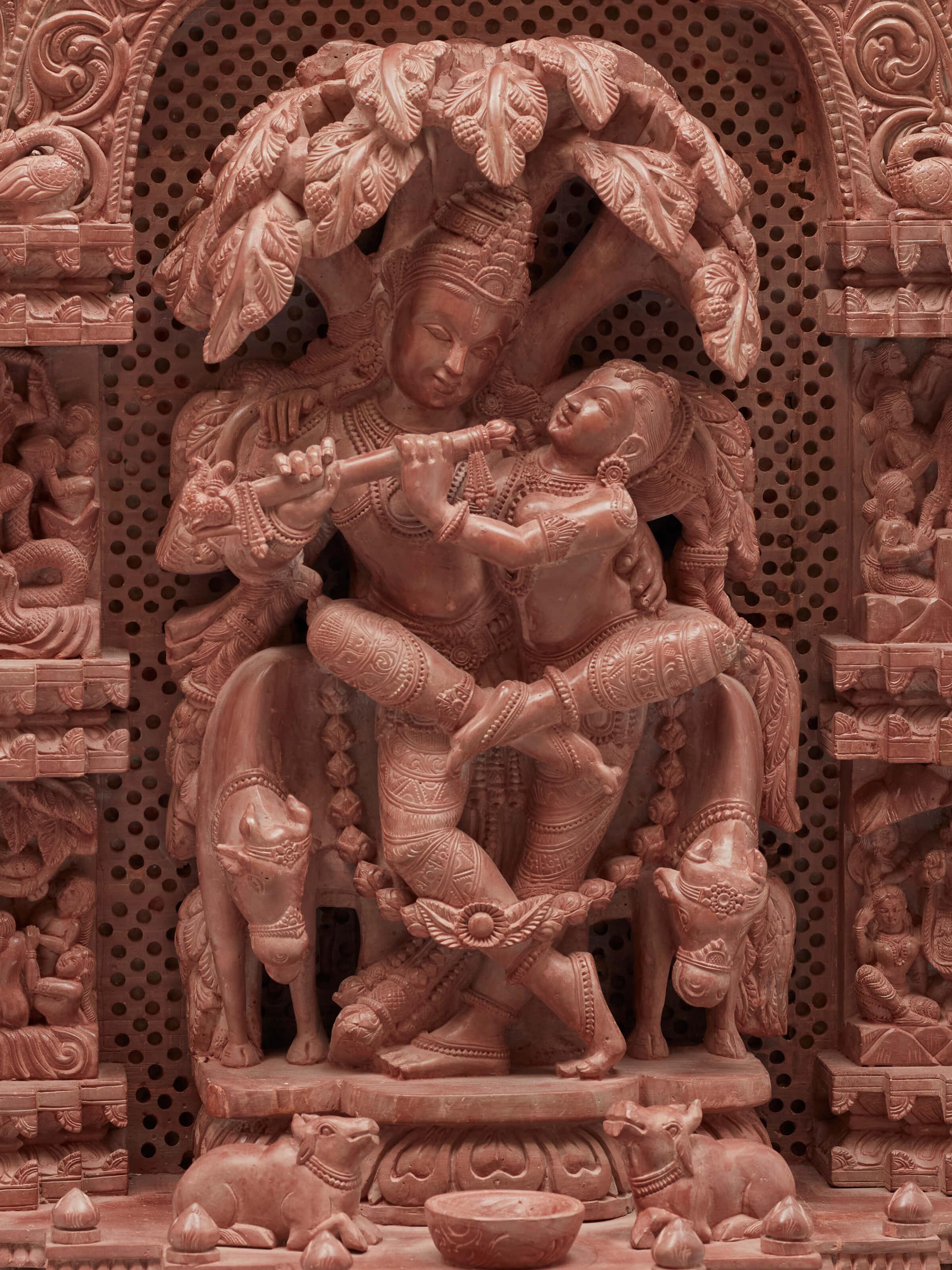 Detailed view of carved stone Radha & Krishna raasa idol capturing fine craftsmanship.