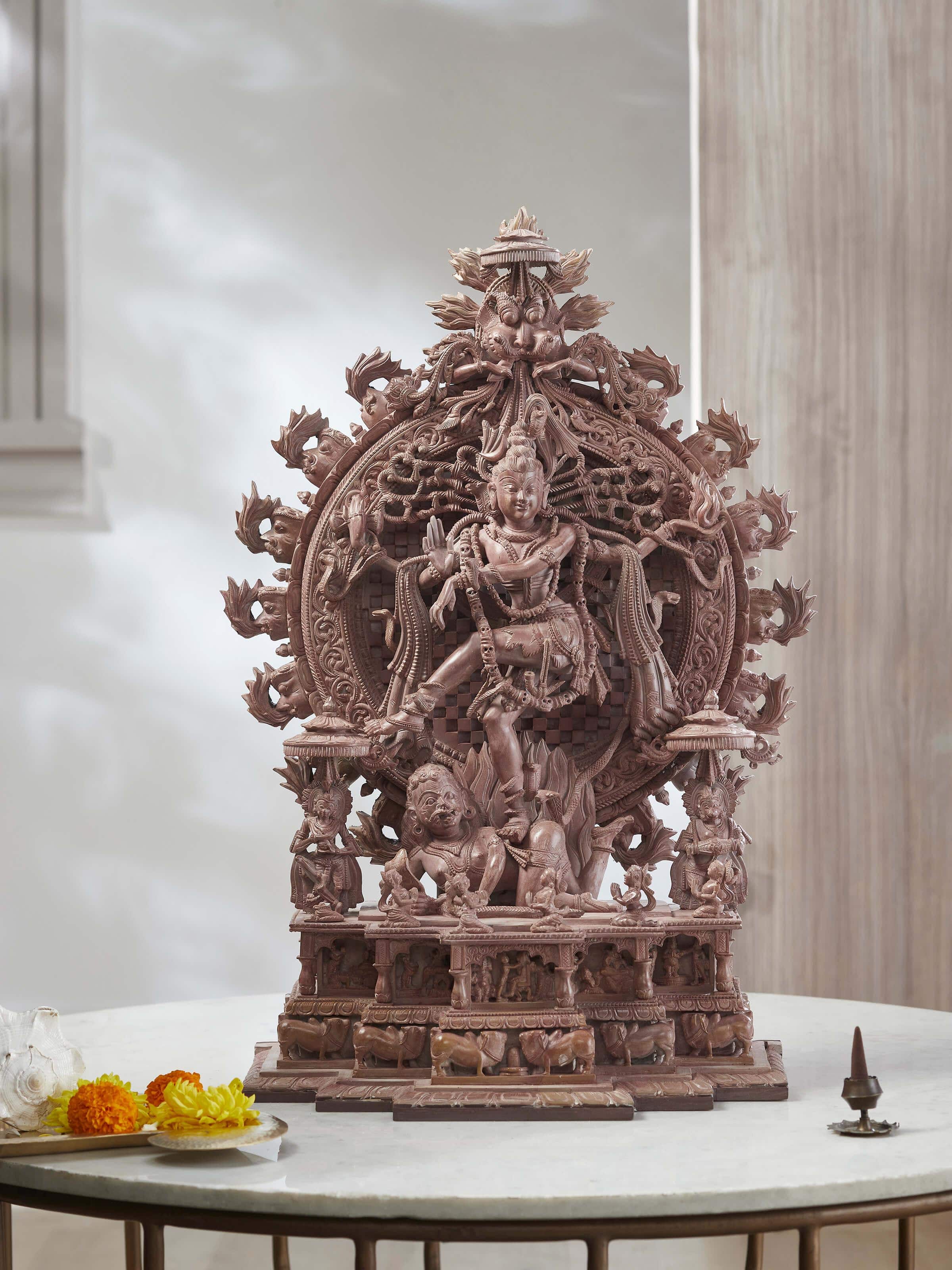 Close-up view of the carved stone Natraj idol, highlighting the detailed craftsmanship and expressive features.