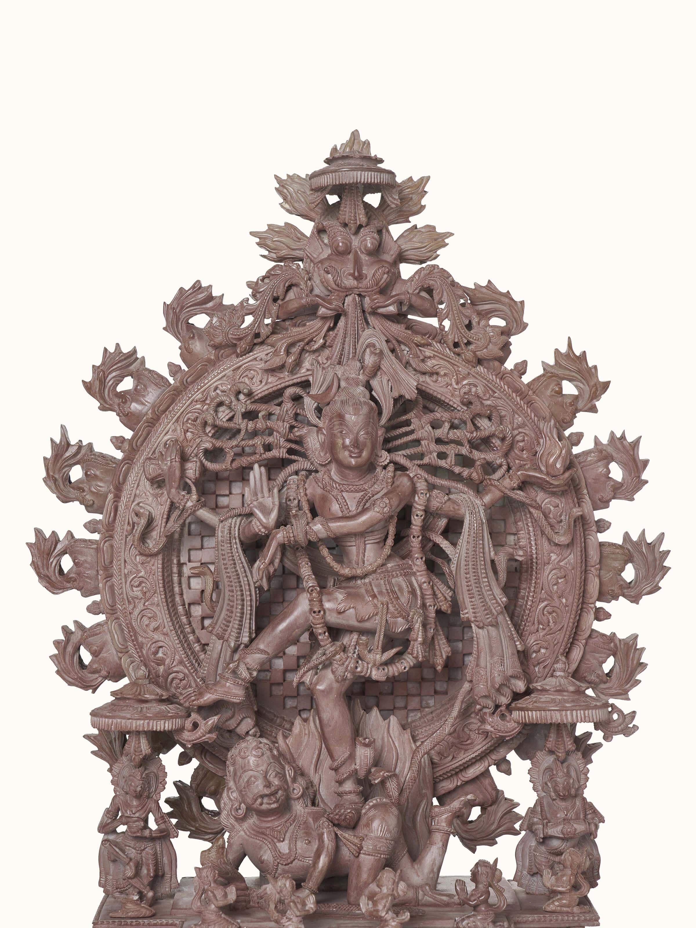 Close-up view of the intricate details in the carved stone Natraj idol, highlighting the craftsmanship.