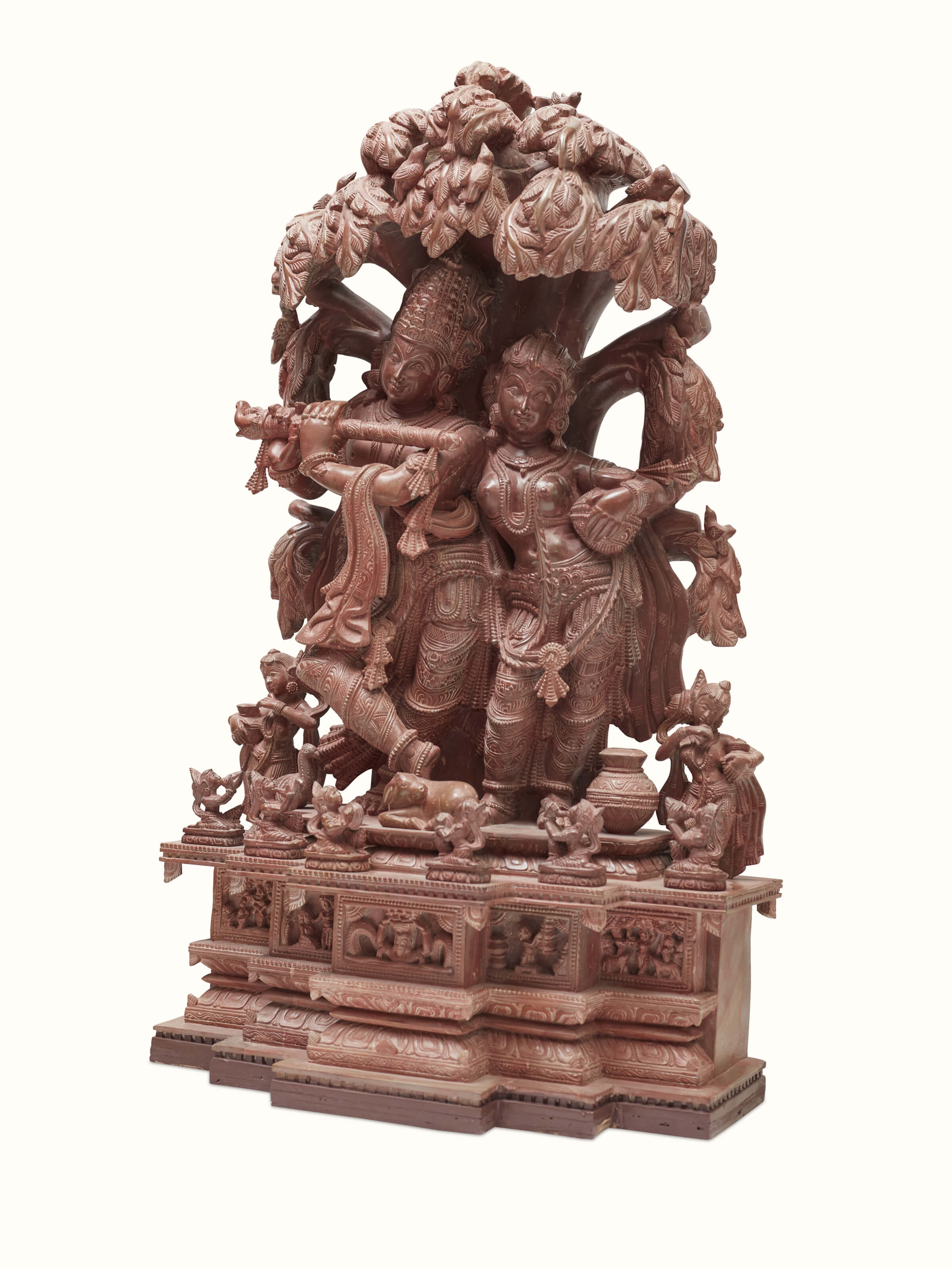 Side view of the Radha & Krishna carved stone idol under the tree.